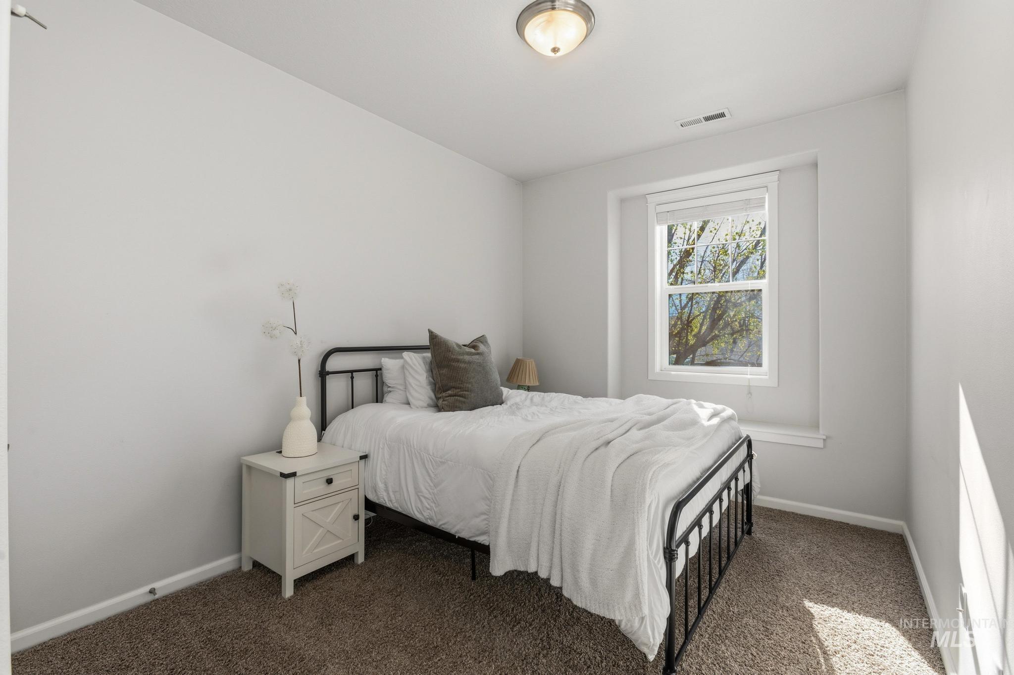 Carpeted bedroom with baseboards