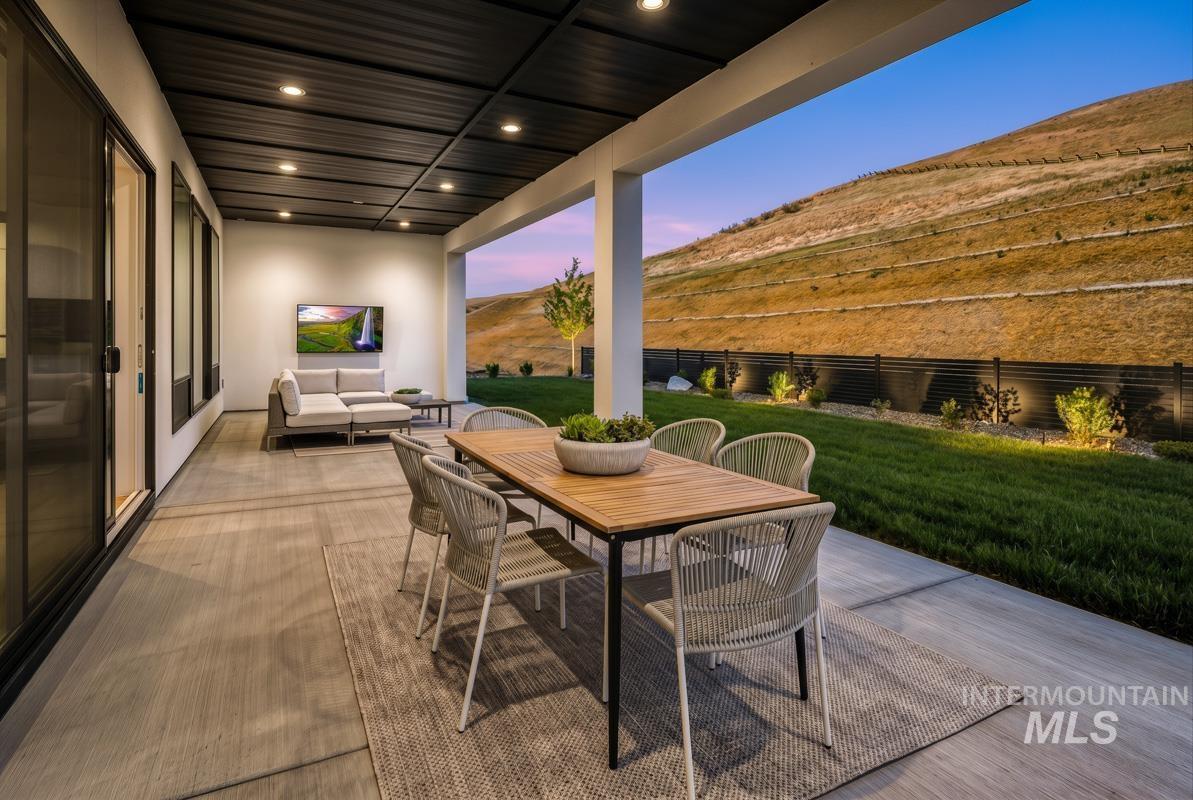 Covered outdoor patio with a flat black ceiling and recessed lighting