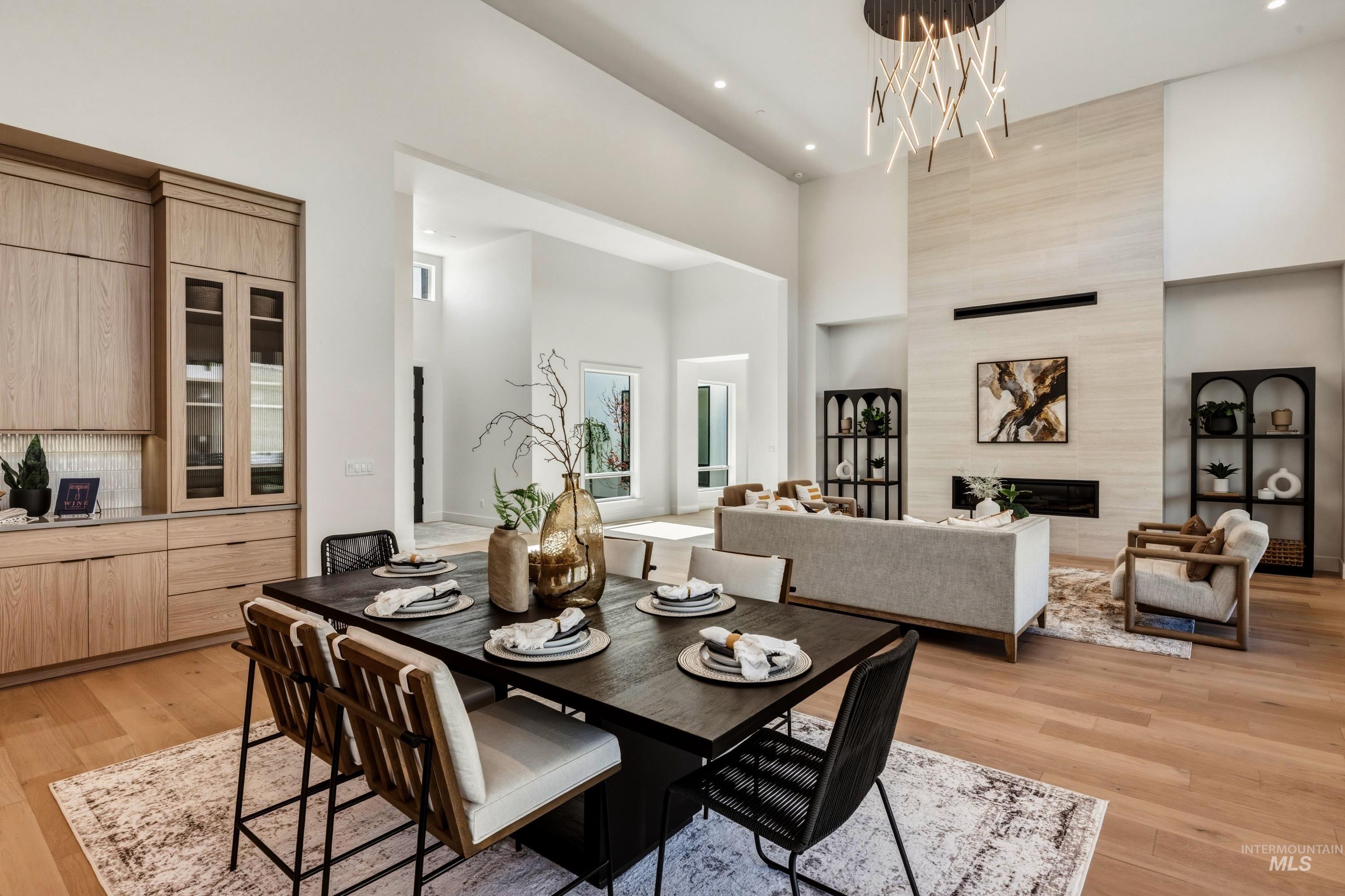 Open-concept dining area featuring a dark-finish dining table and wood-finish flooring