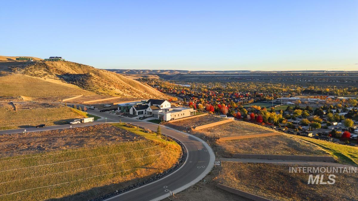 Hillside building lots featuring tiered landscaping and paved roads