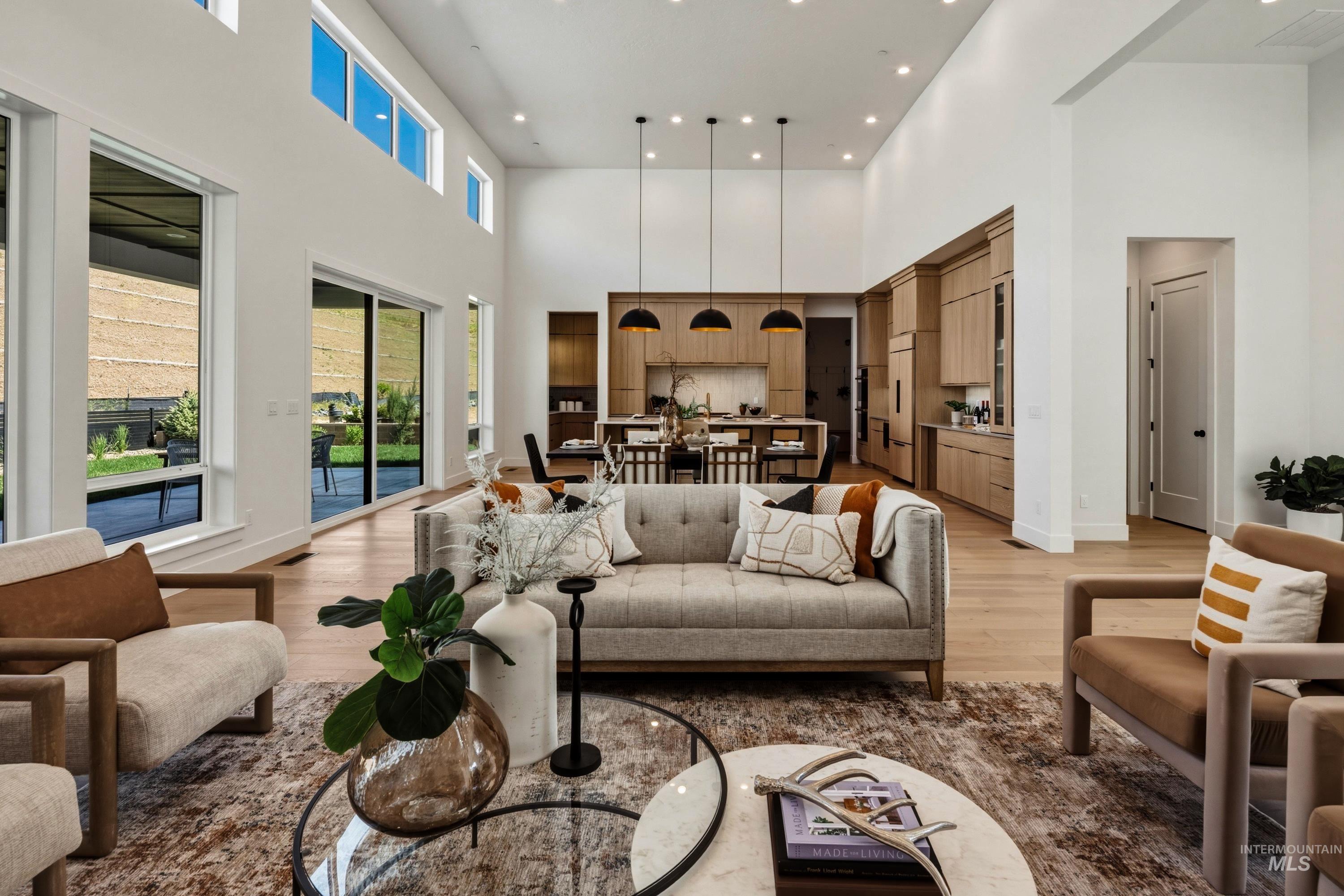 Vaulted ceilings and wood-finish flooring define this expansive living space