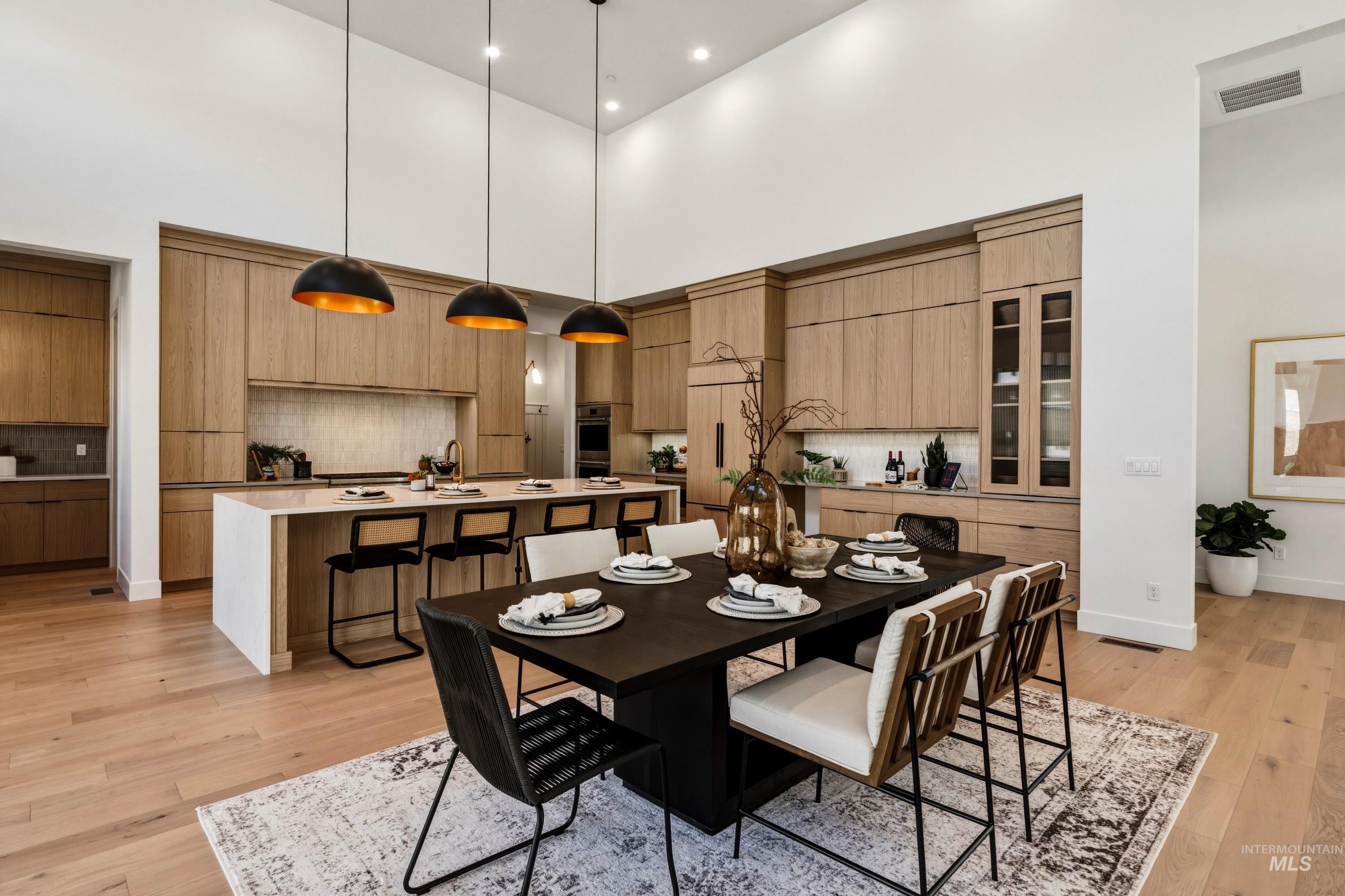 Vaulted ceilings accentuating the open-concept kitchen and dining area