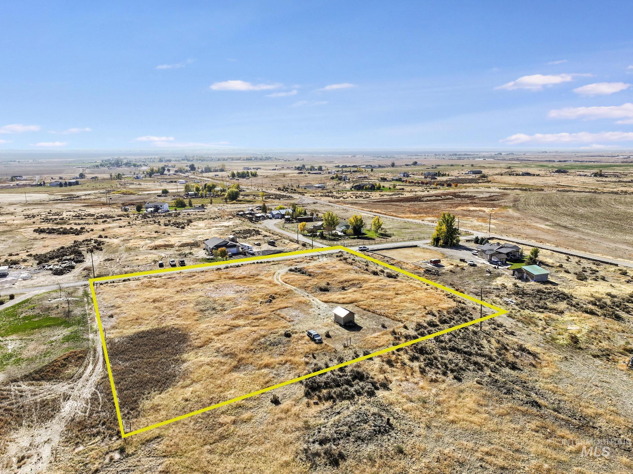 Aerial view of sparsely populated area with property boundaries highlighted and a desert landscape