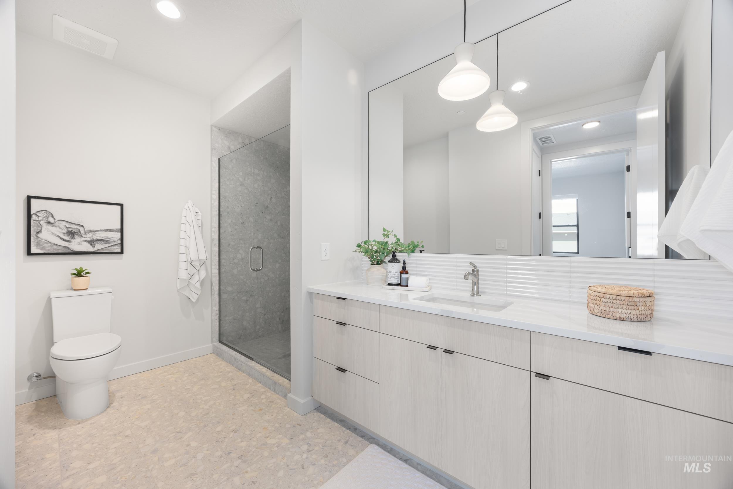 Full bath featuring vanity, a shower stall, and recessed lighting