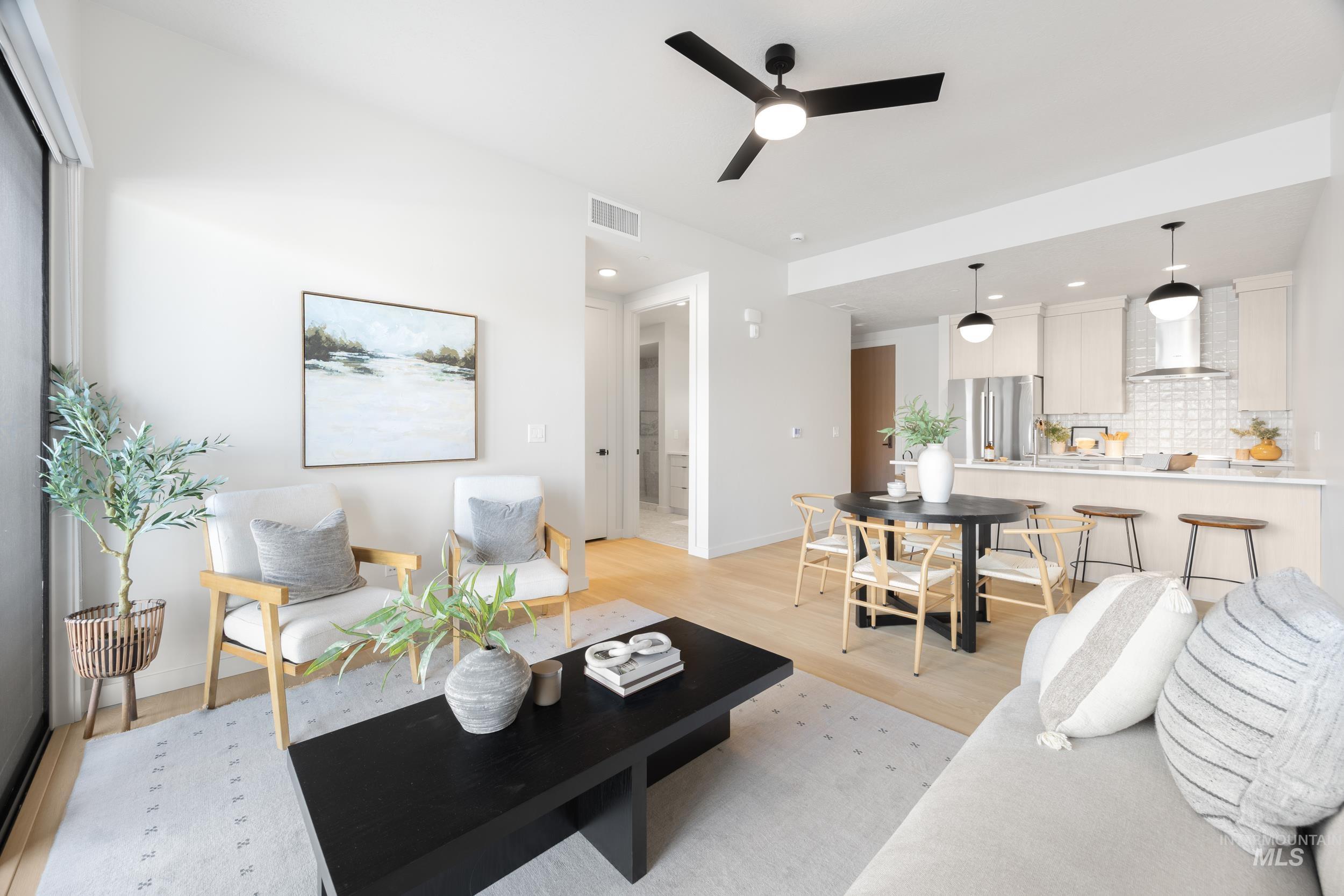 Living room with recessed lighting, light wood-type flooring, and ceiling fan