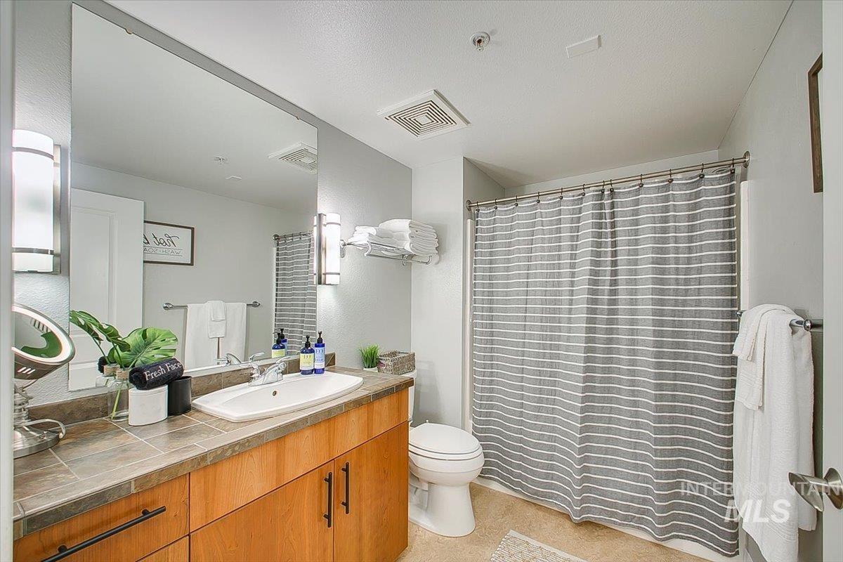 Full bathroom with vanity and a shower with curtain
