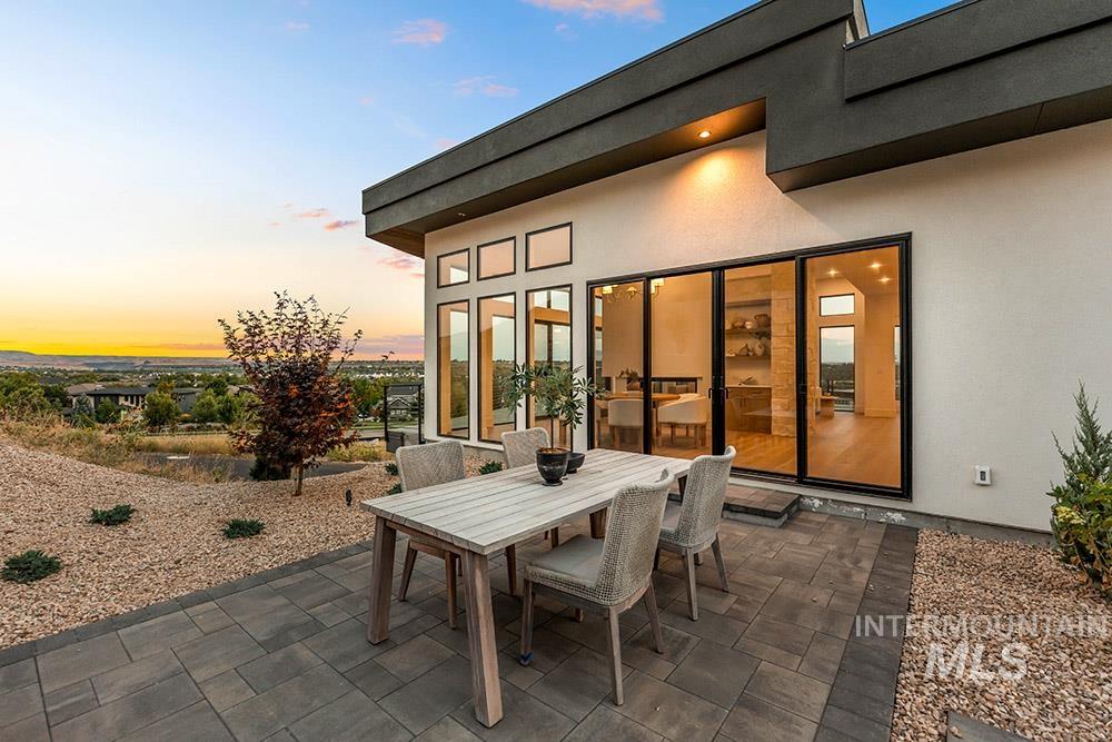 Patio terrace at dusk with outdoor dining area and a patio area
