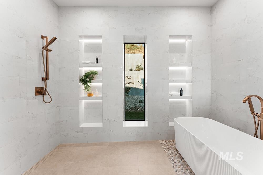 Full bath with a freestanding bath and tile walls