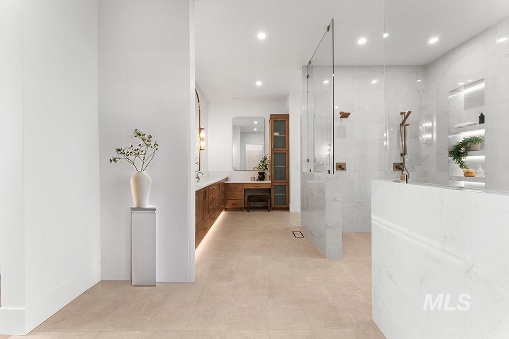 Full bathroom with vanity, a marble finish shower, recessed lighting, and light tile patterned floors