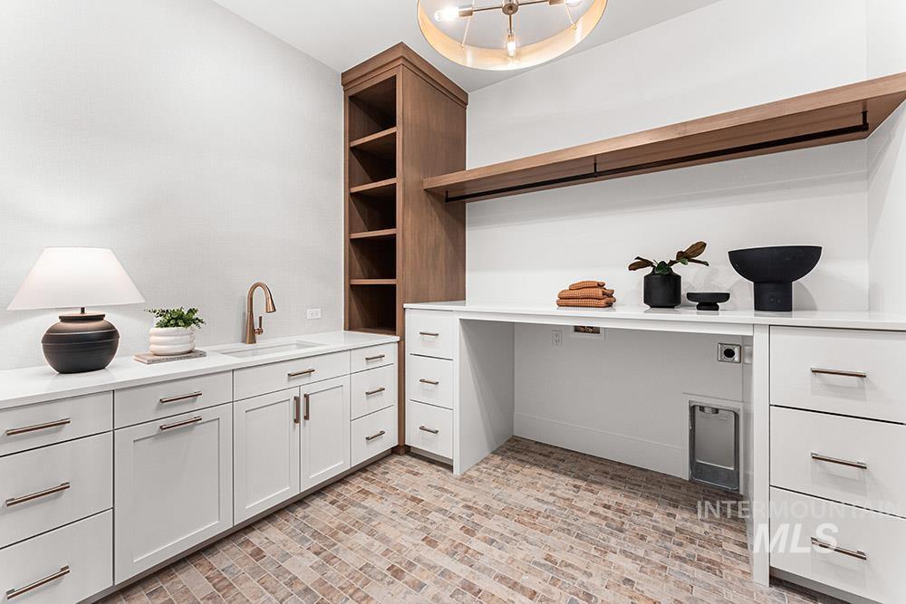 Office space with a sink and brick patterned floors
