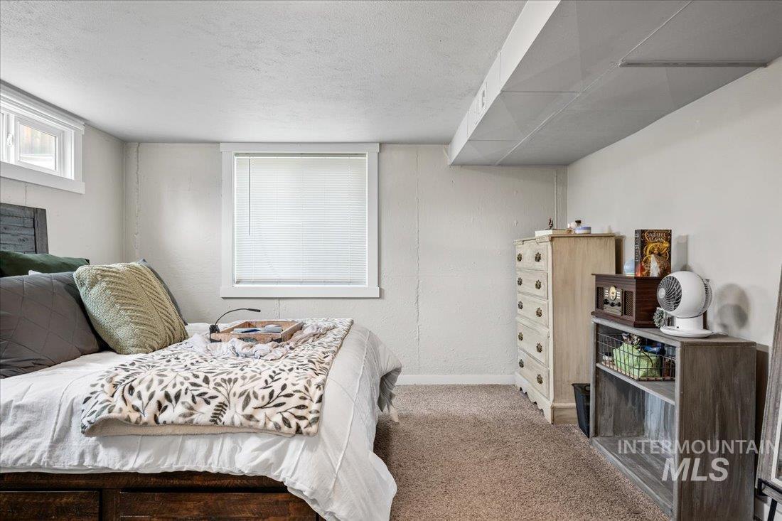 Bedroom featuring carpet floors and a textured ceiling