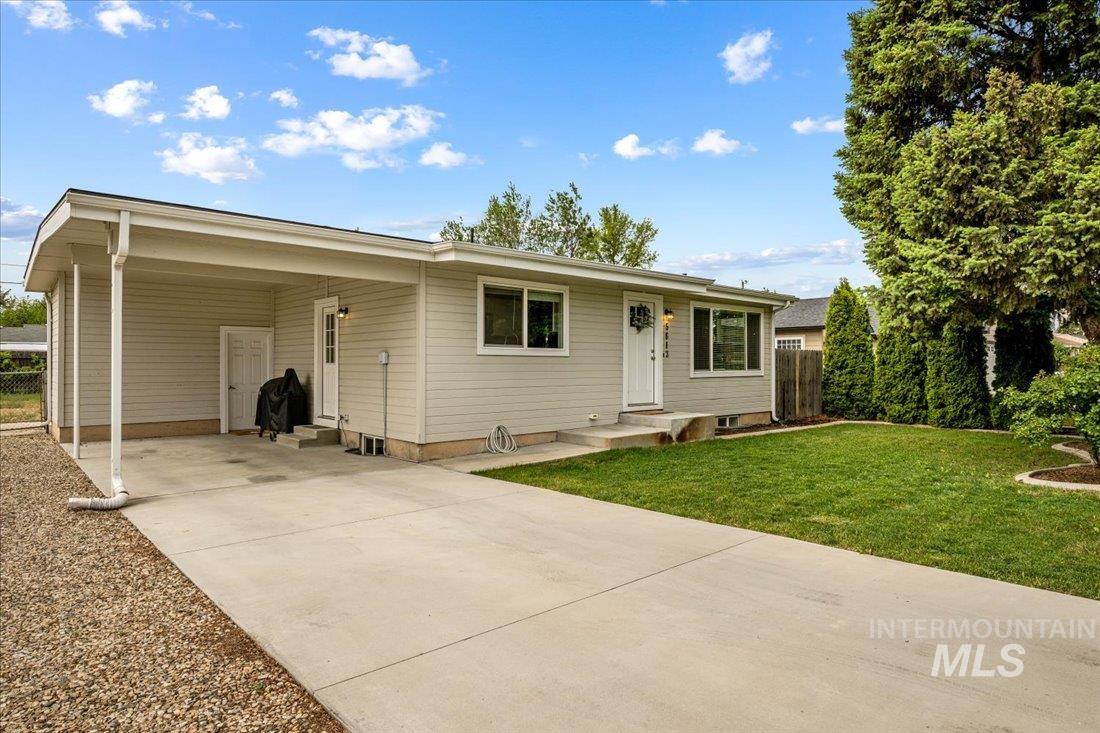 Ranch-style home featuring driveway, an attached carport, and entry steps