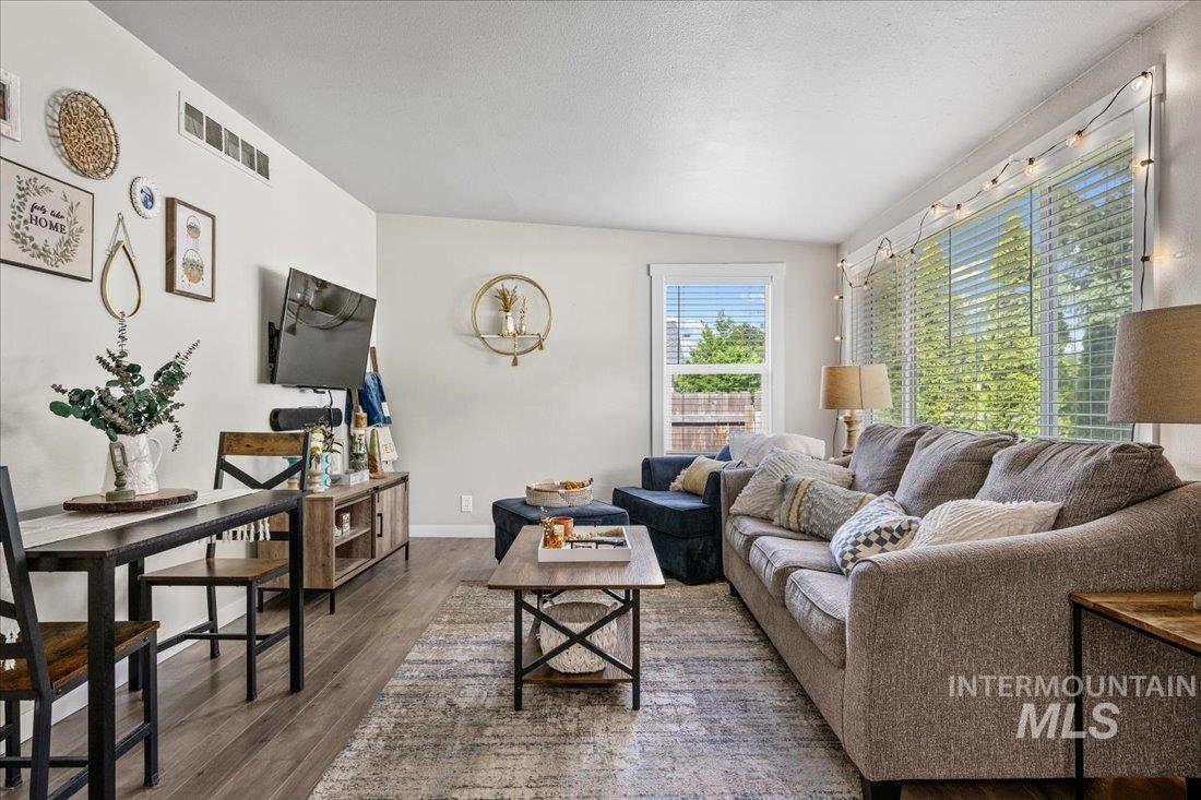 Living area with wood finished floors and lofted ceiling