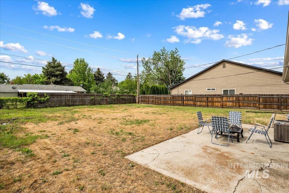 Fenced backyard with a patio area