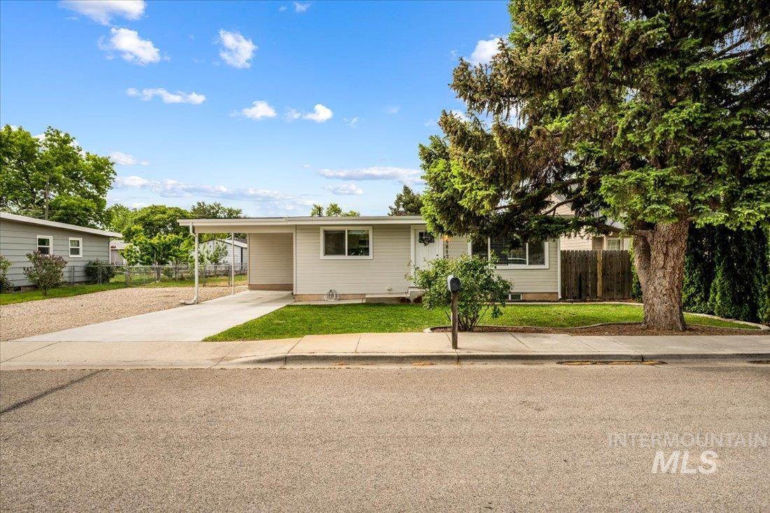 View of front of house with driveway and a carport