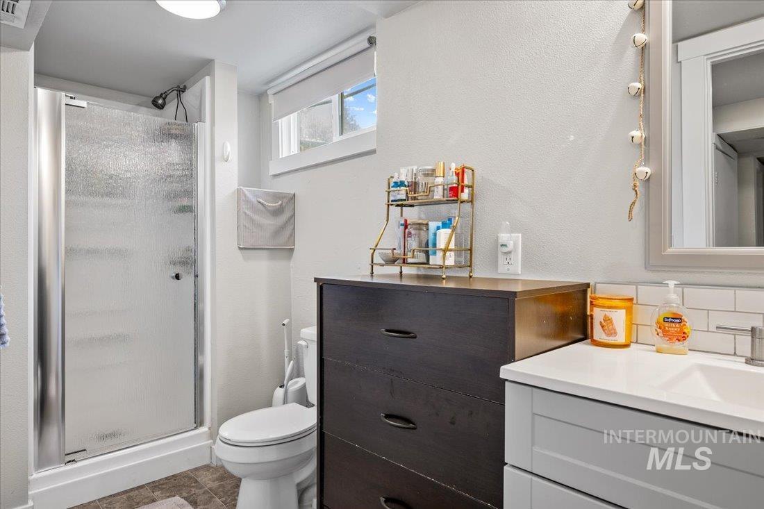 Bathroom with vanity and a stall shower