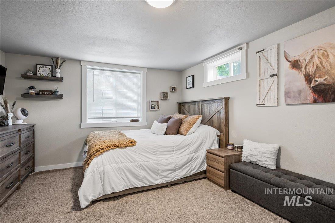 Bedroom with carpet flooring and a textured ceiling