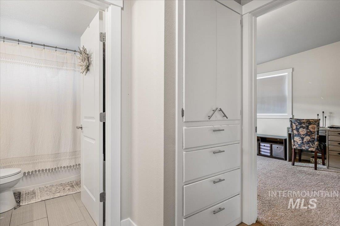 Bathroom featuring a shower with shower curtain