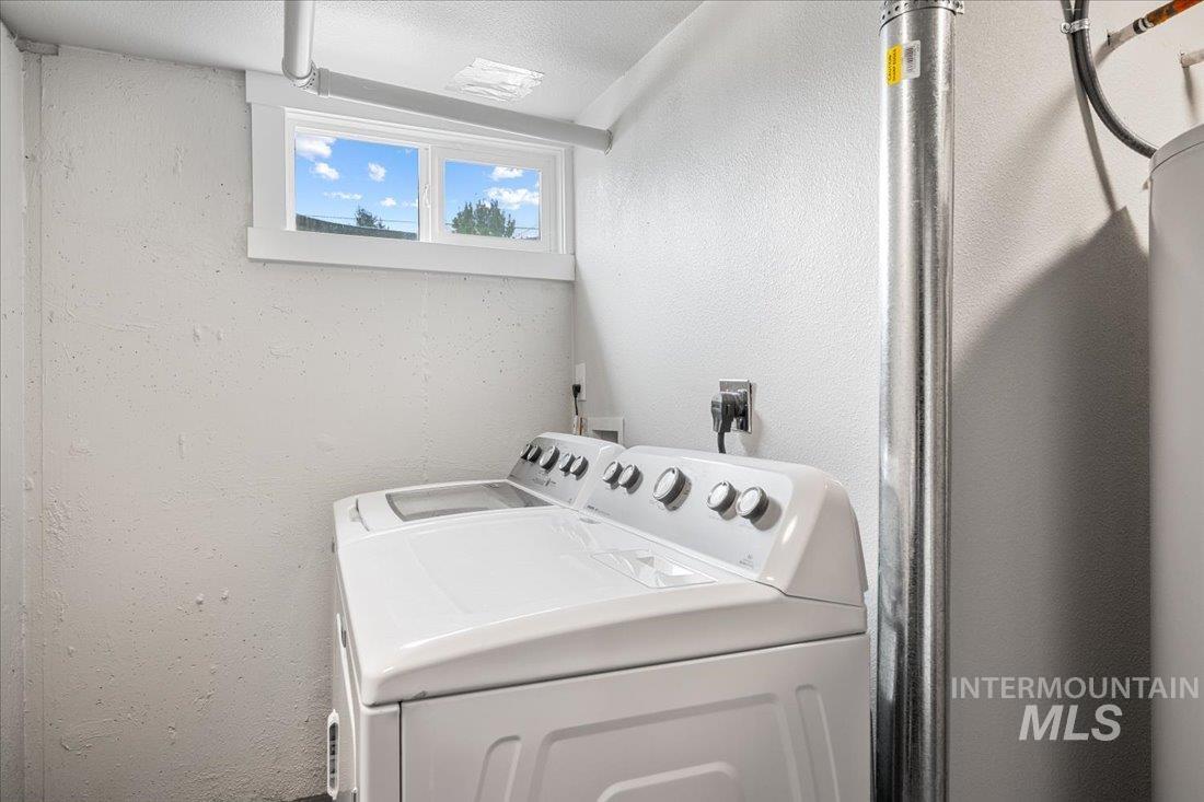 Laundry room with washer and clothes dryer