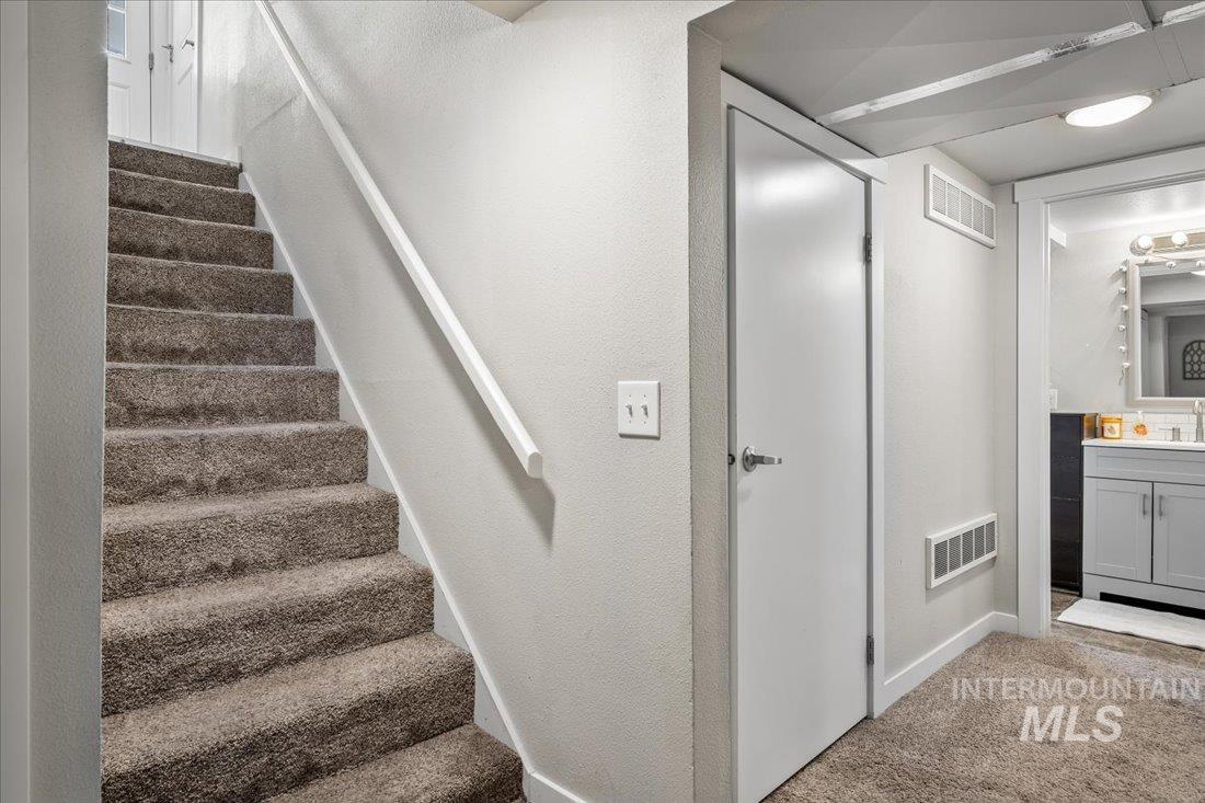 Stairs with carpet floors and baseboards