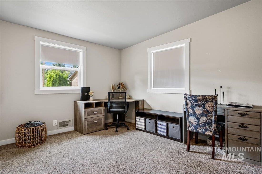Office area featuring carpet and baseboards