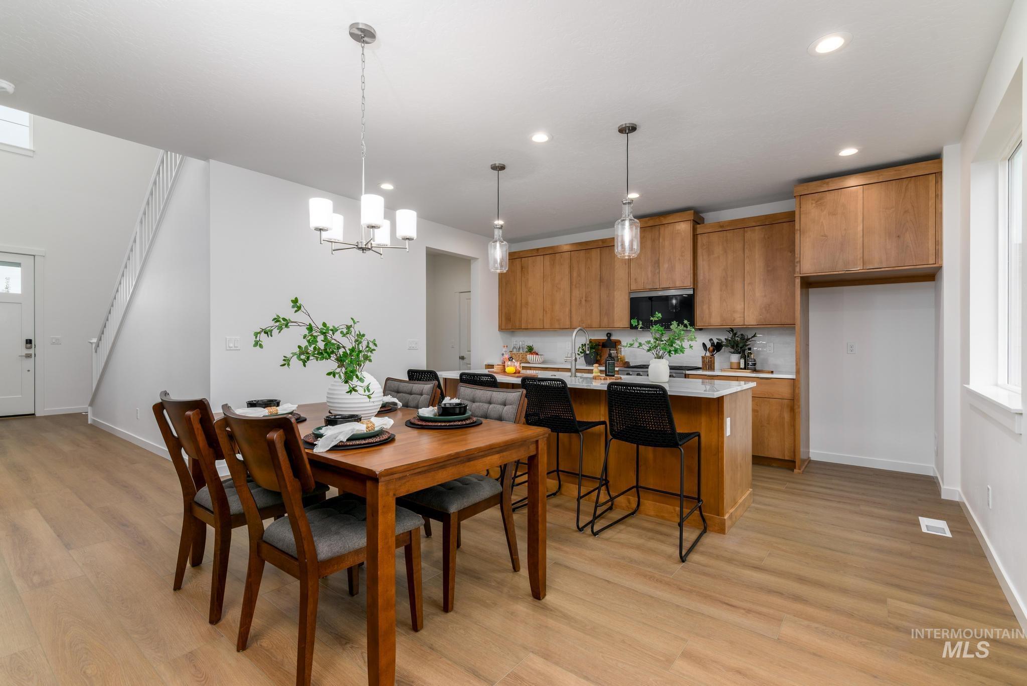 Dining area featuring light wood-style floors, a chandelier, and recessed lighting