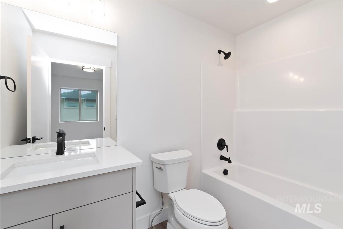 Full bath featuring tub / shower combination and vanity