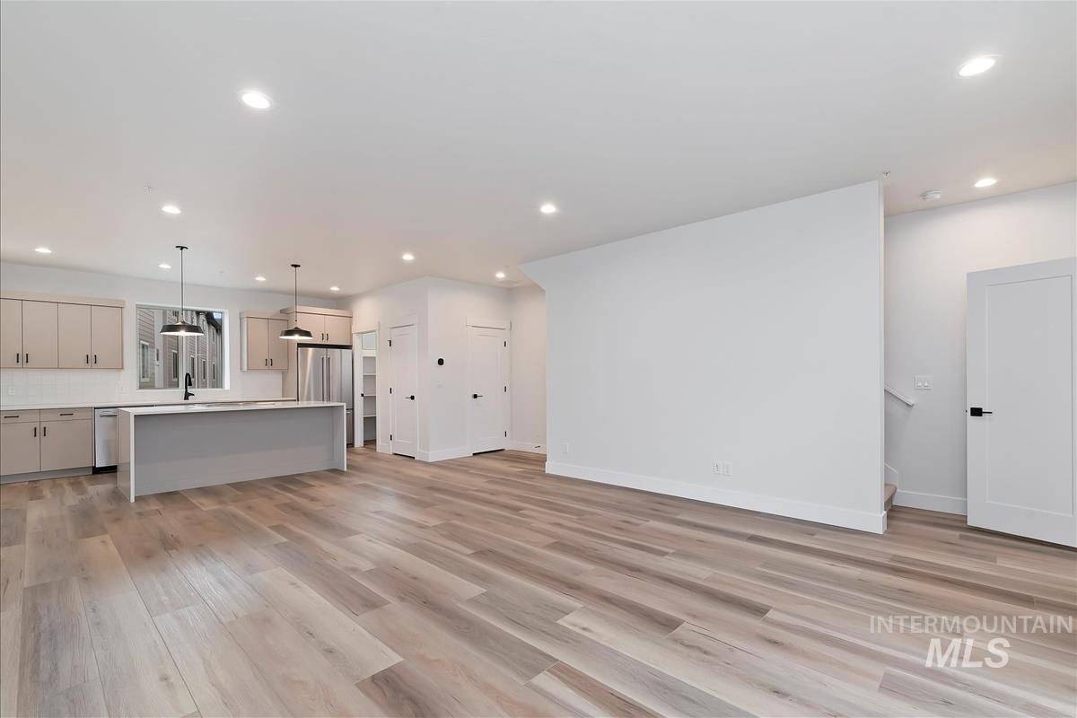 Unfurnished living room with light wood finished floors and recessed lighting