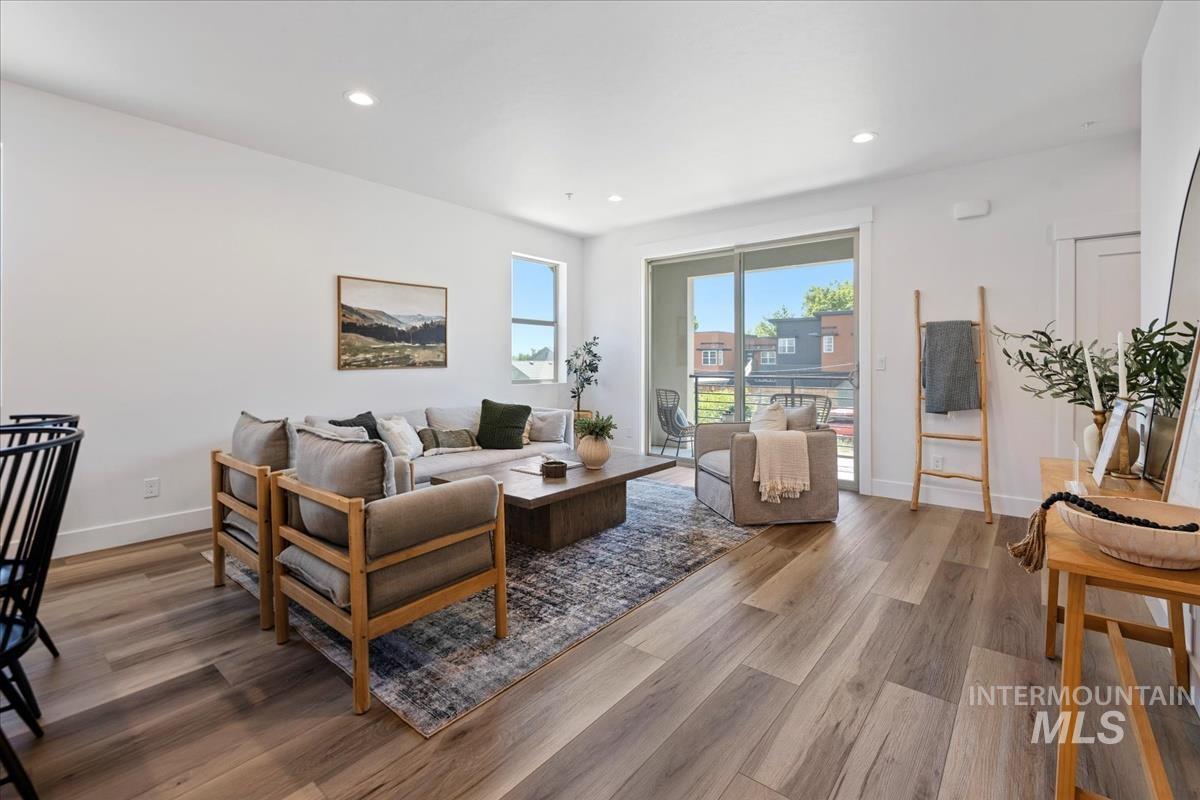 Living area featuring wood finished floors and recessed lighting