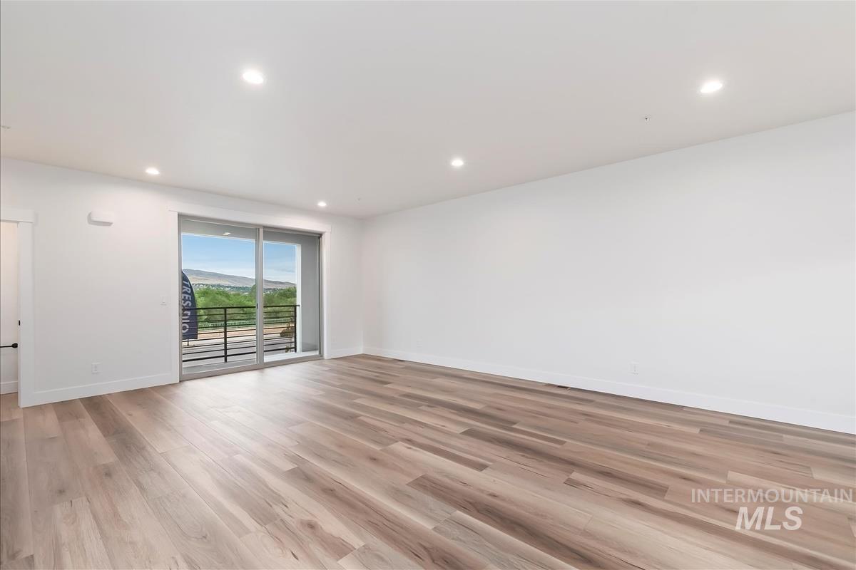 Unfurnished room with light wood-style flooring and recessed lighting