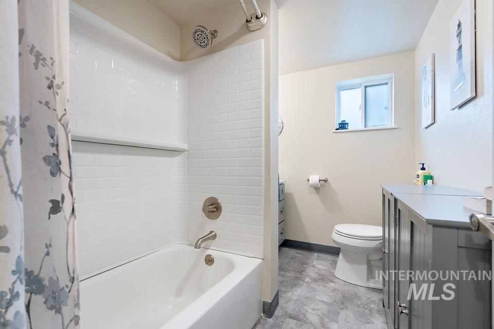 Full bath featuring vanity and shower / tub combo with curtain