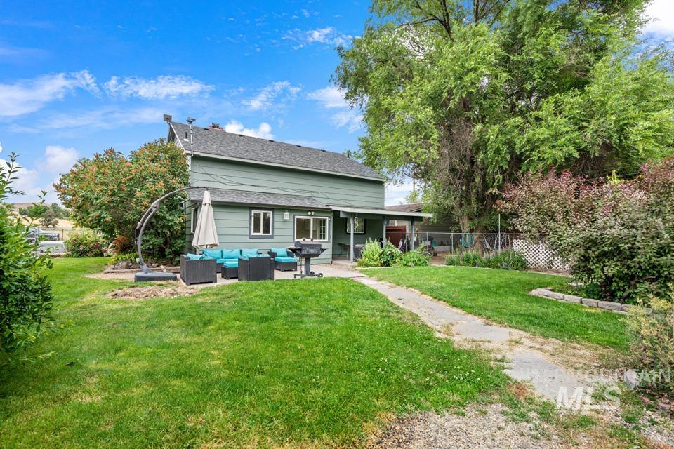 Rear view of house with a patio and an outdoor living space
