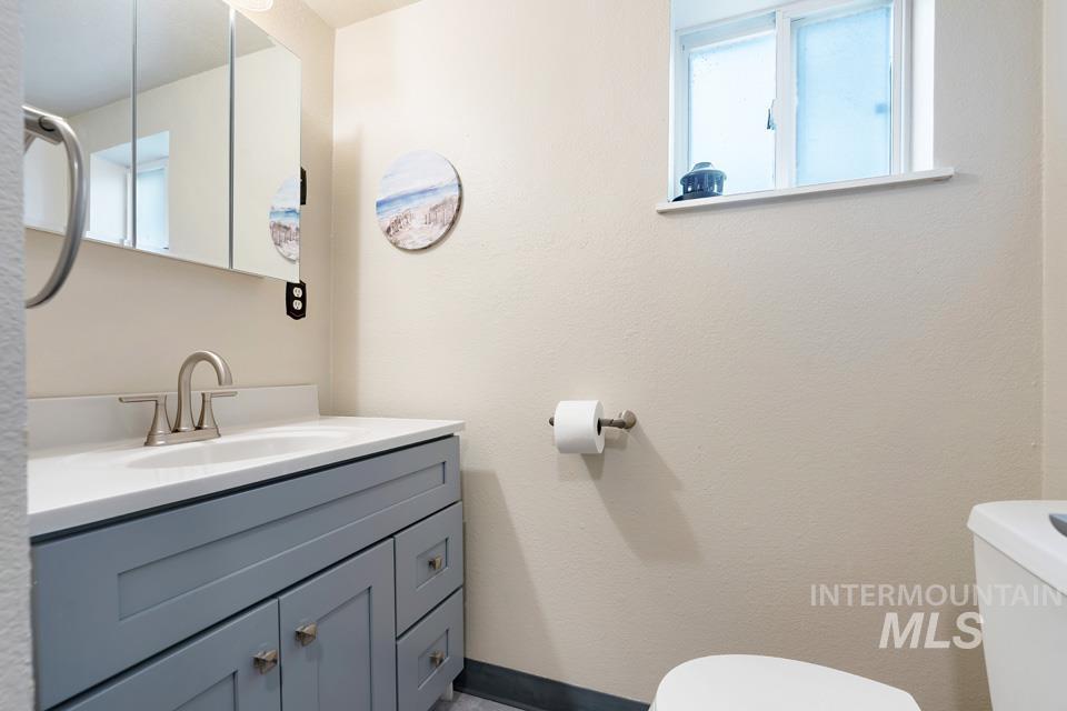 Half bath featuring toilet and vanity