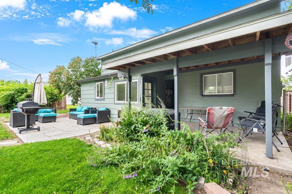 Back of house featuring a patio area and an outdoor living space