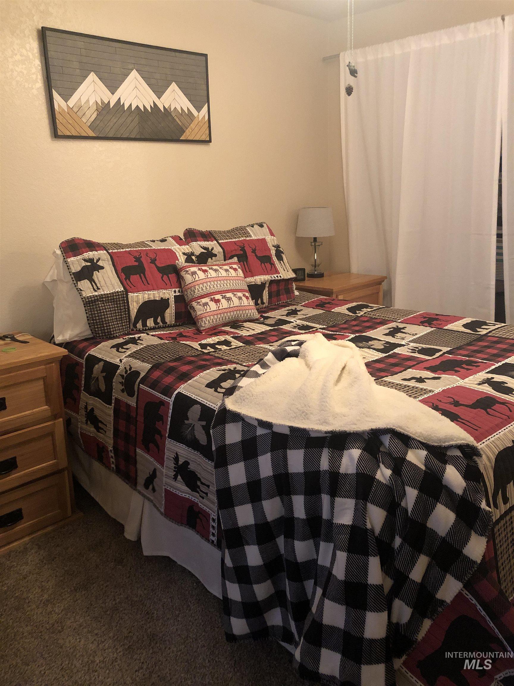 Bedroom featuring dark colored carpet