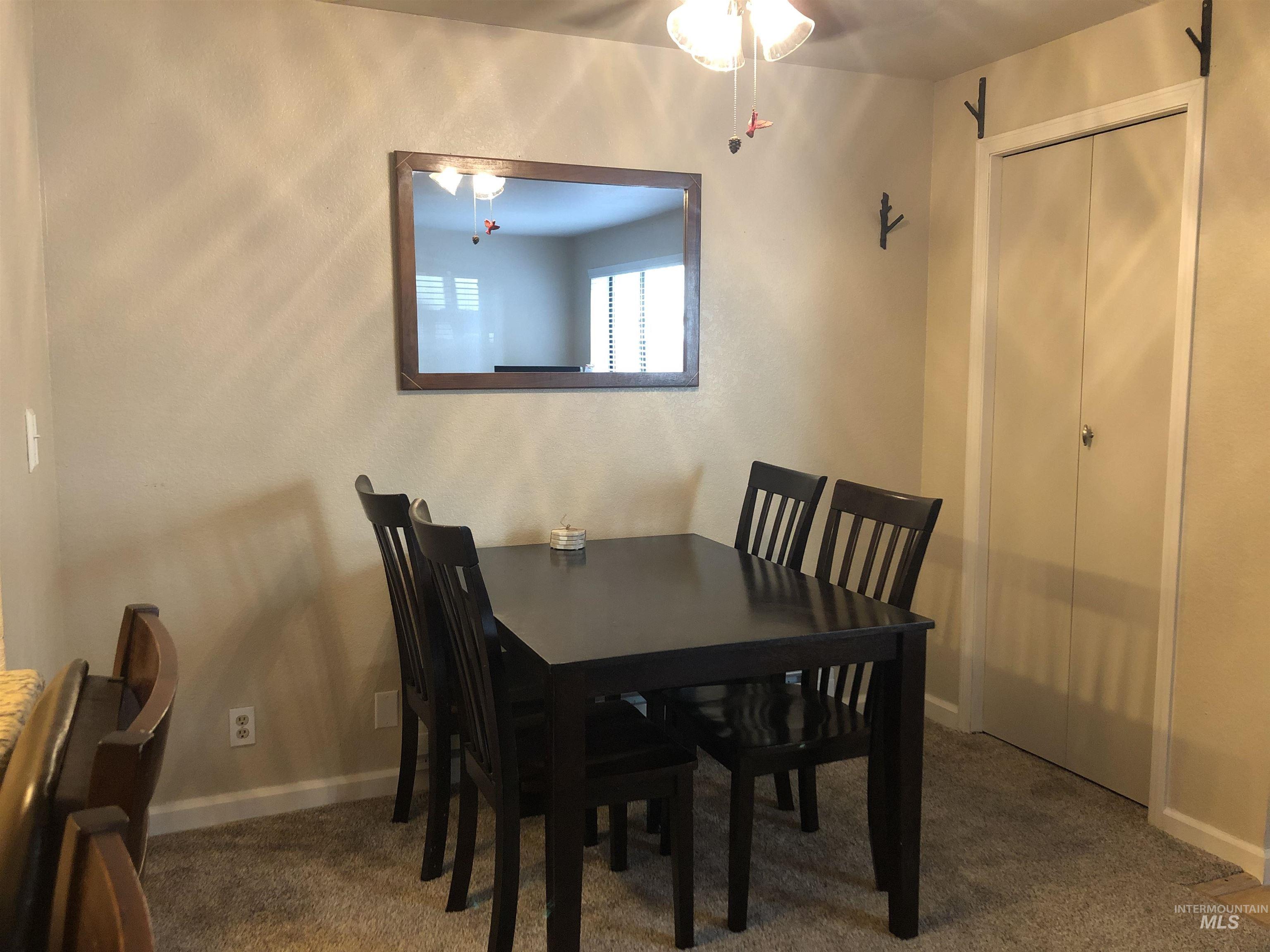 Dining room with dark carpet