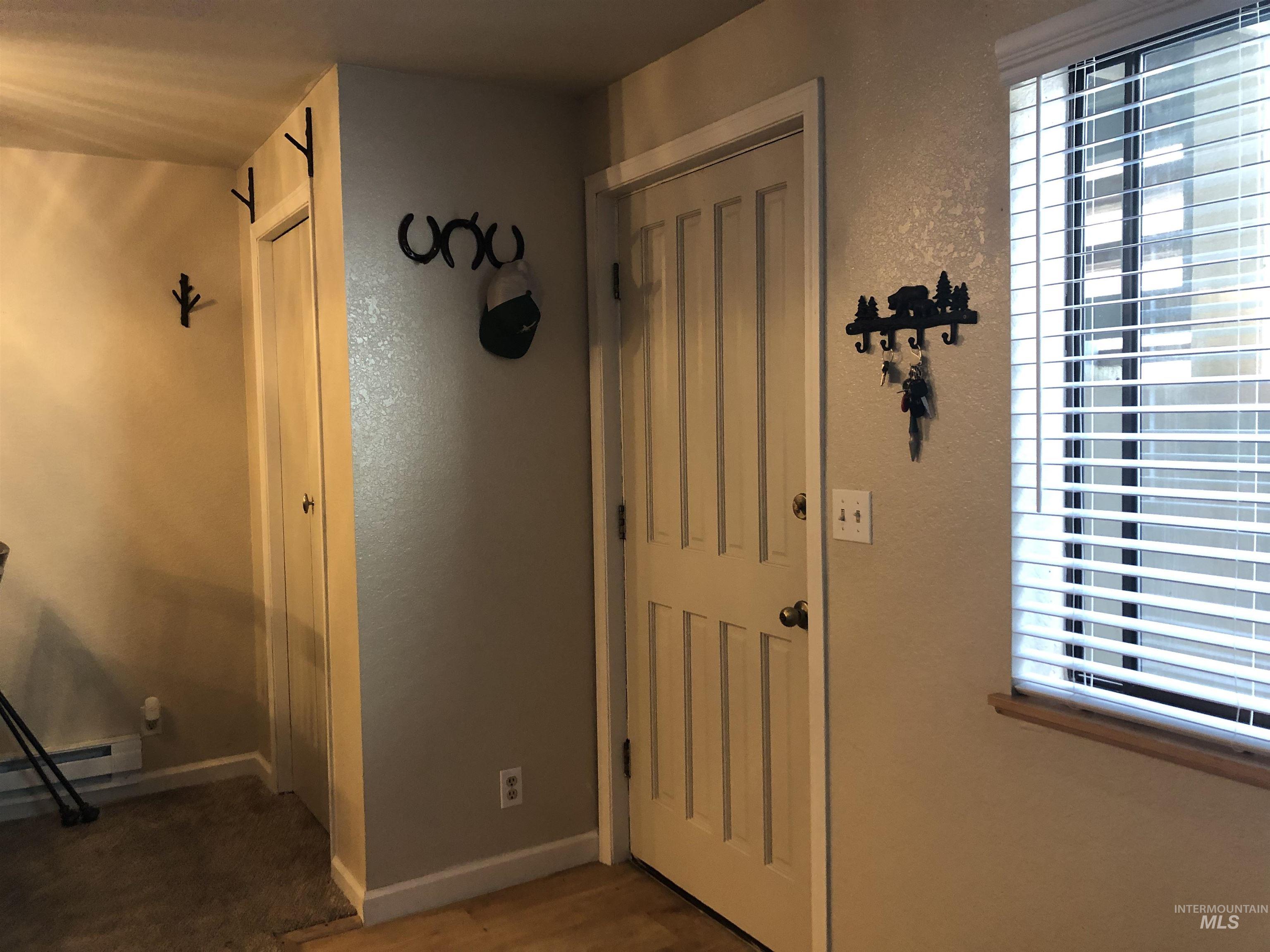 Foyer with a textured wall and wood finished floors