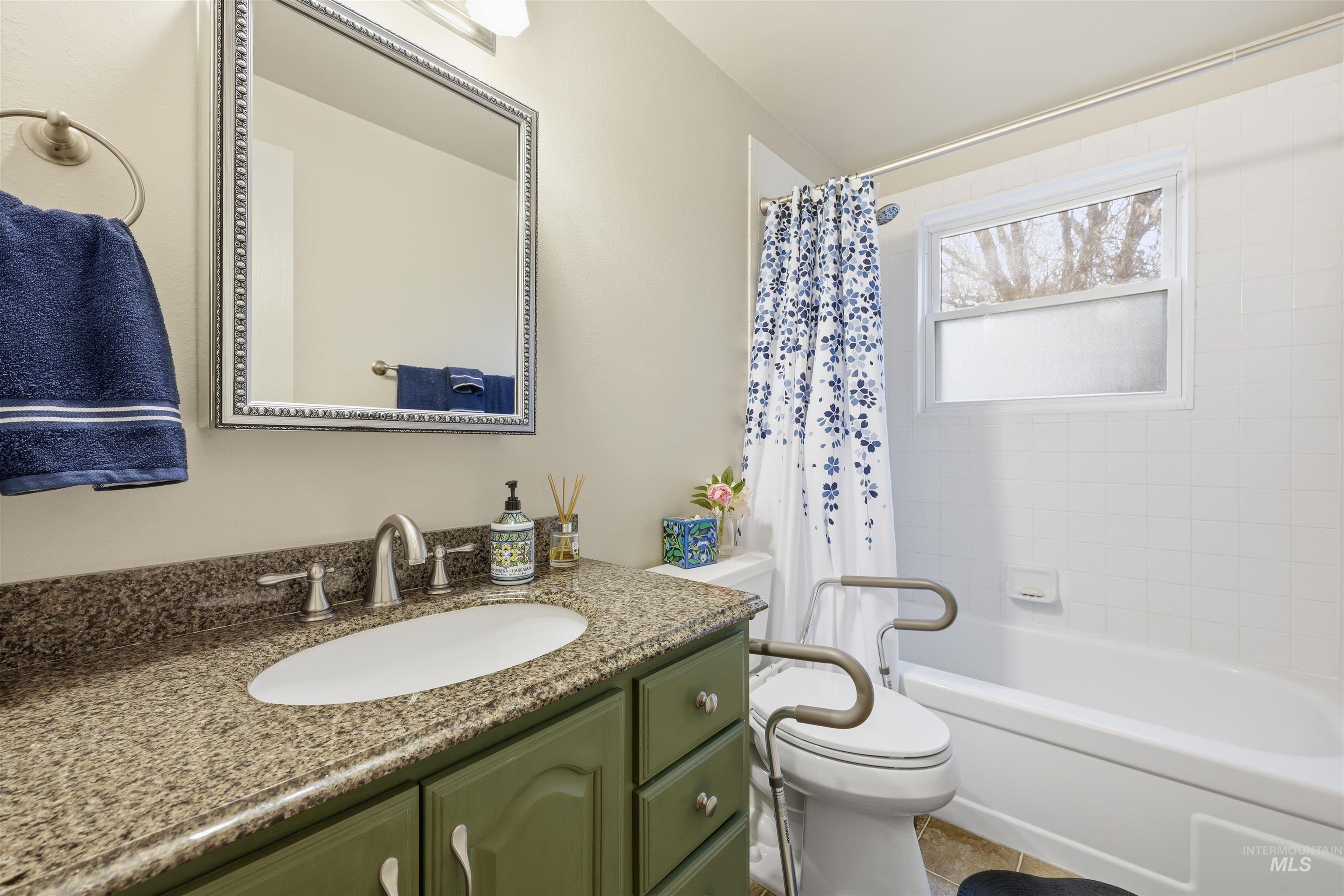 Bathroom with vanity and shower / bath combo