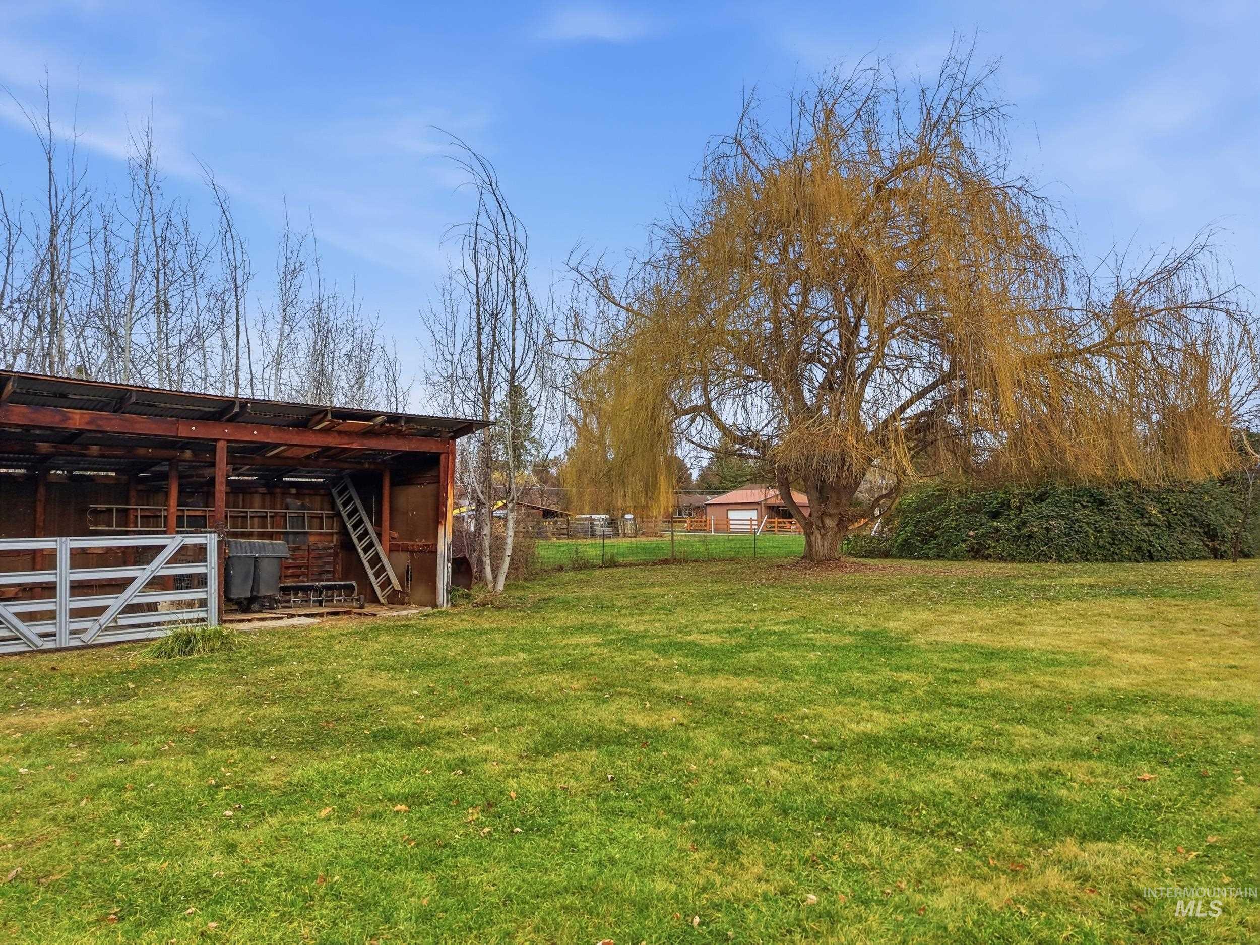 View of yard with an outbuilding and a pole building