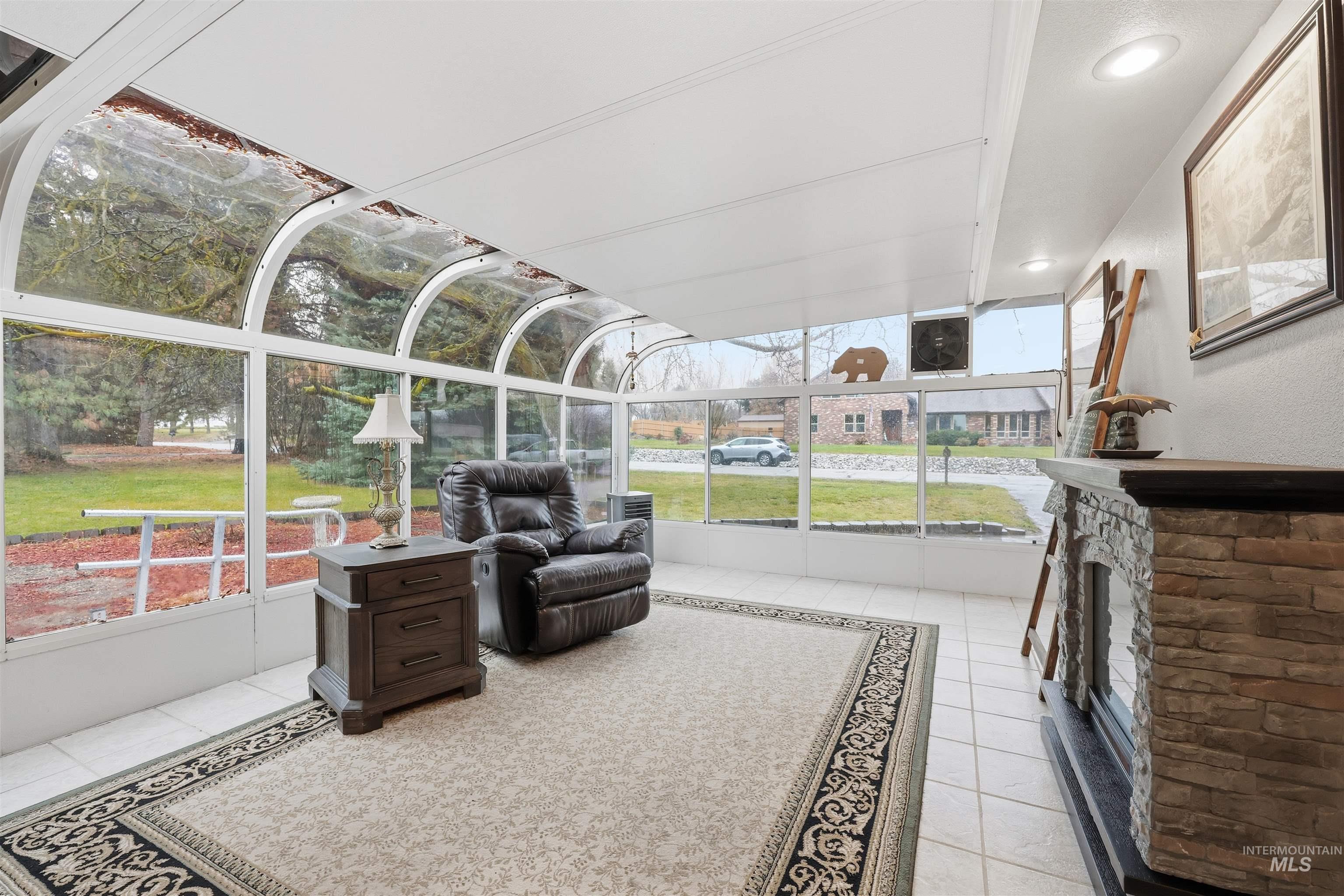 Sunroom / solarium with a fireplace