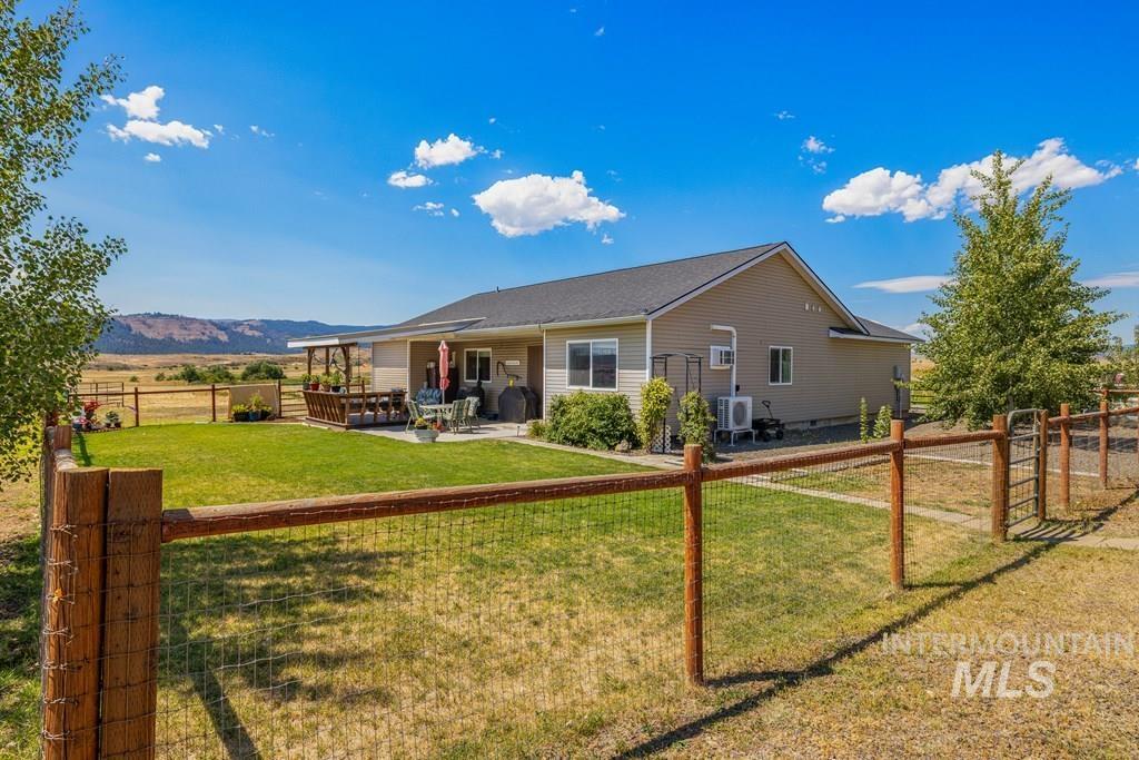 Back of property with a fenced backyard and a patio
