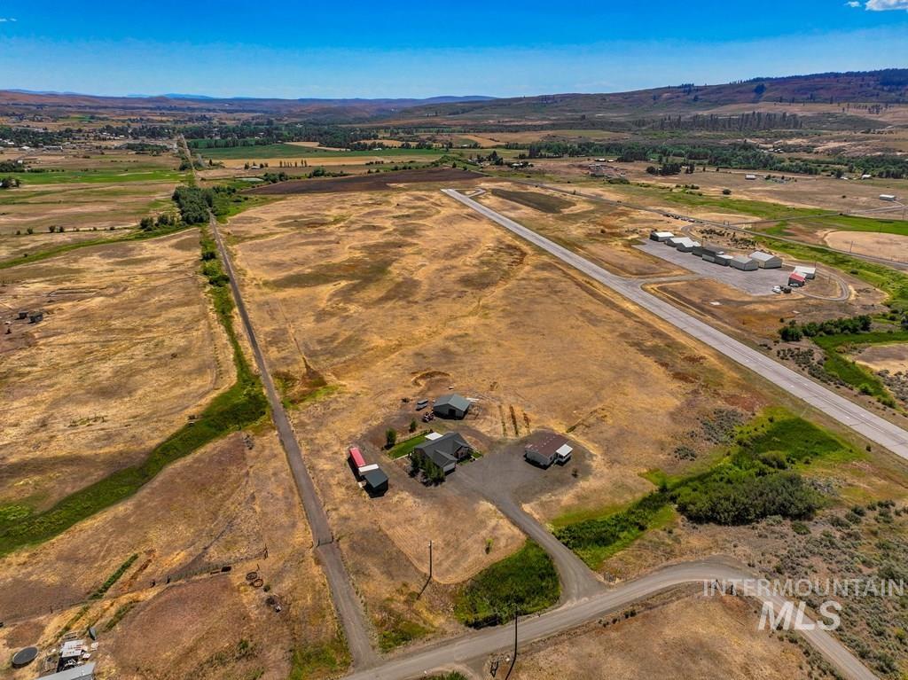 Aerial overview of property's location featuring rural landscape and a mountainous background