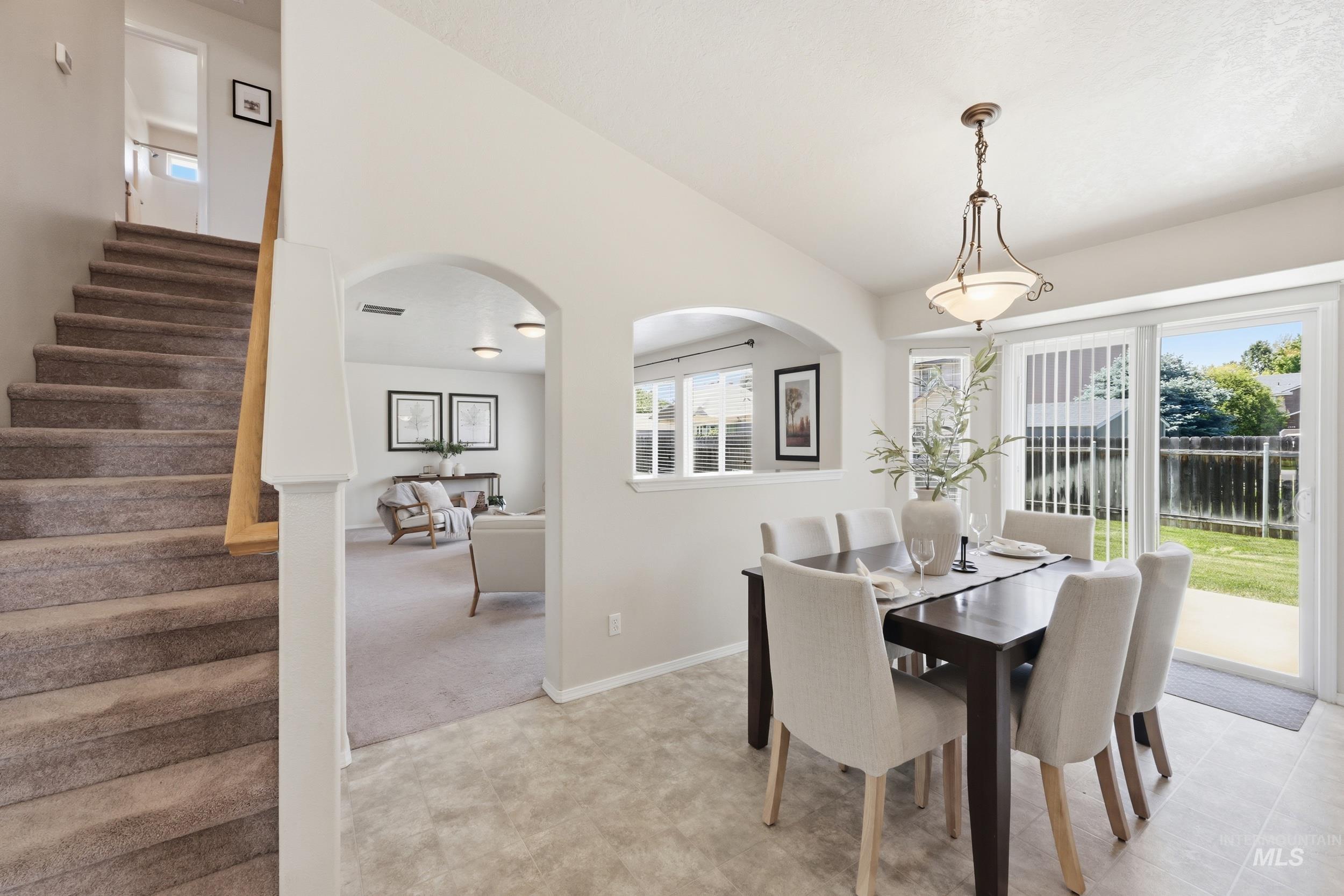 Dining area featuring a contemporary chandelier and sliding glass doors to the exterior