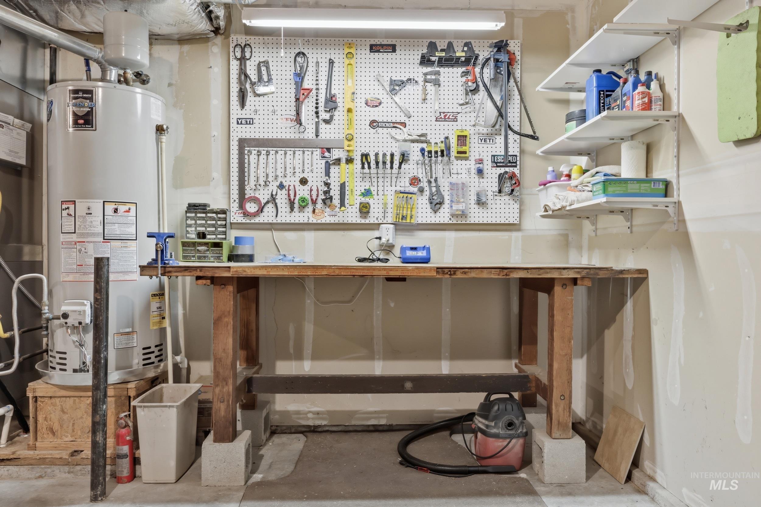 Utility area featuring a built-in workbench, pegboard storage, and wall-mounted shelving
