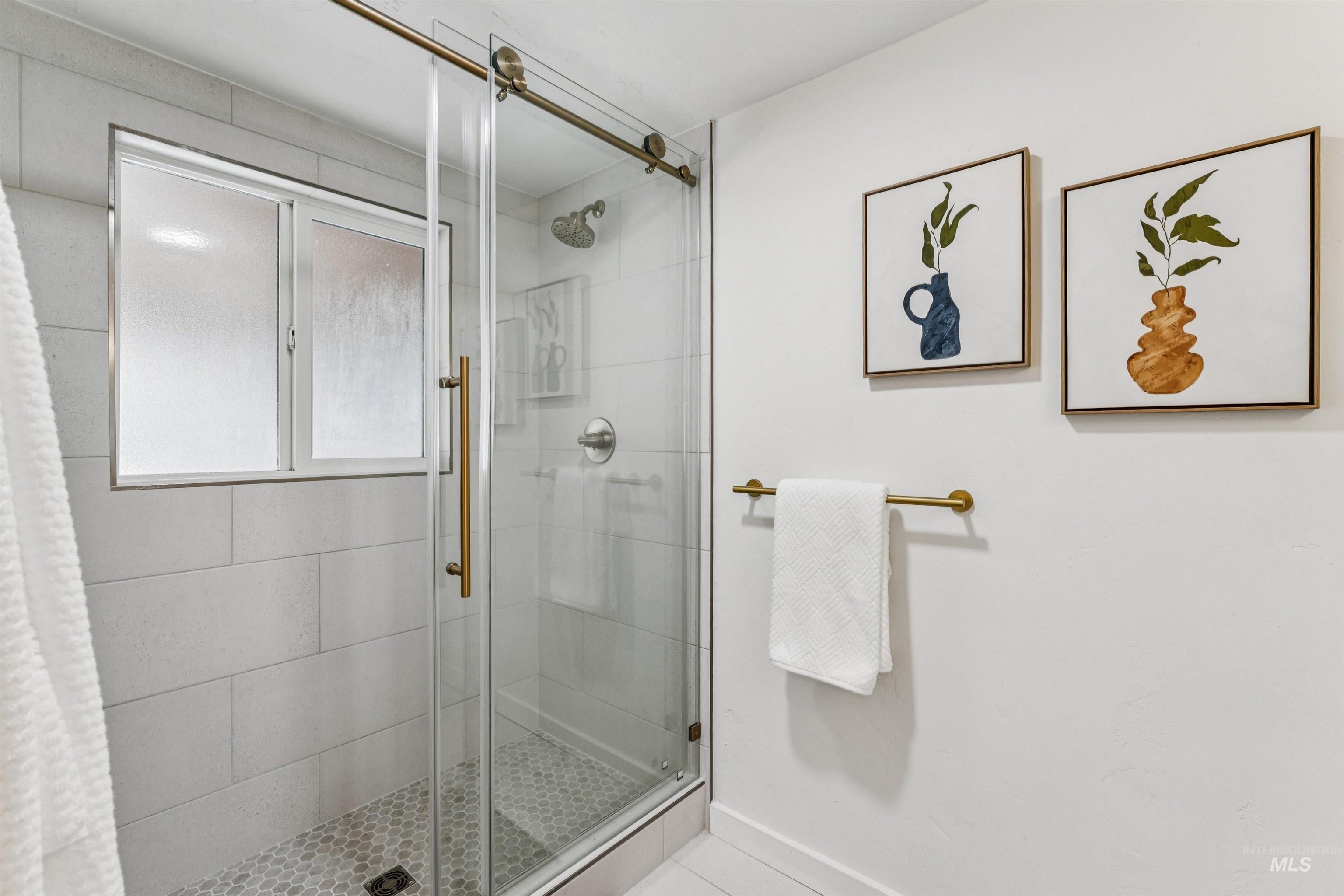 Full bathroom featuring a stall shower and tile patterned flooring