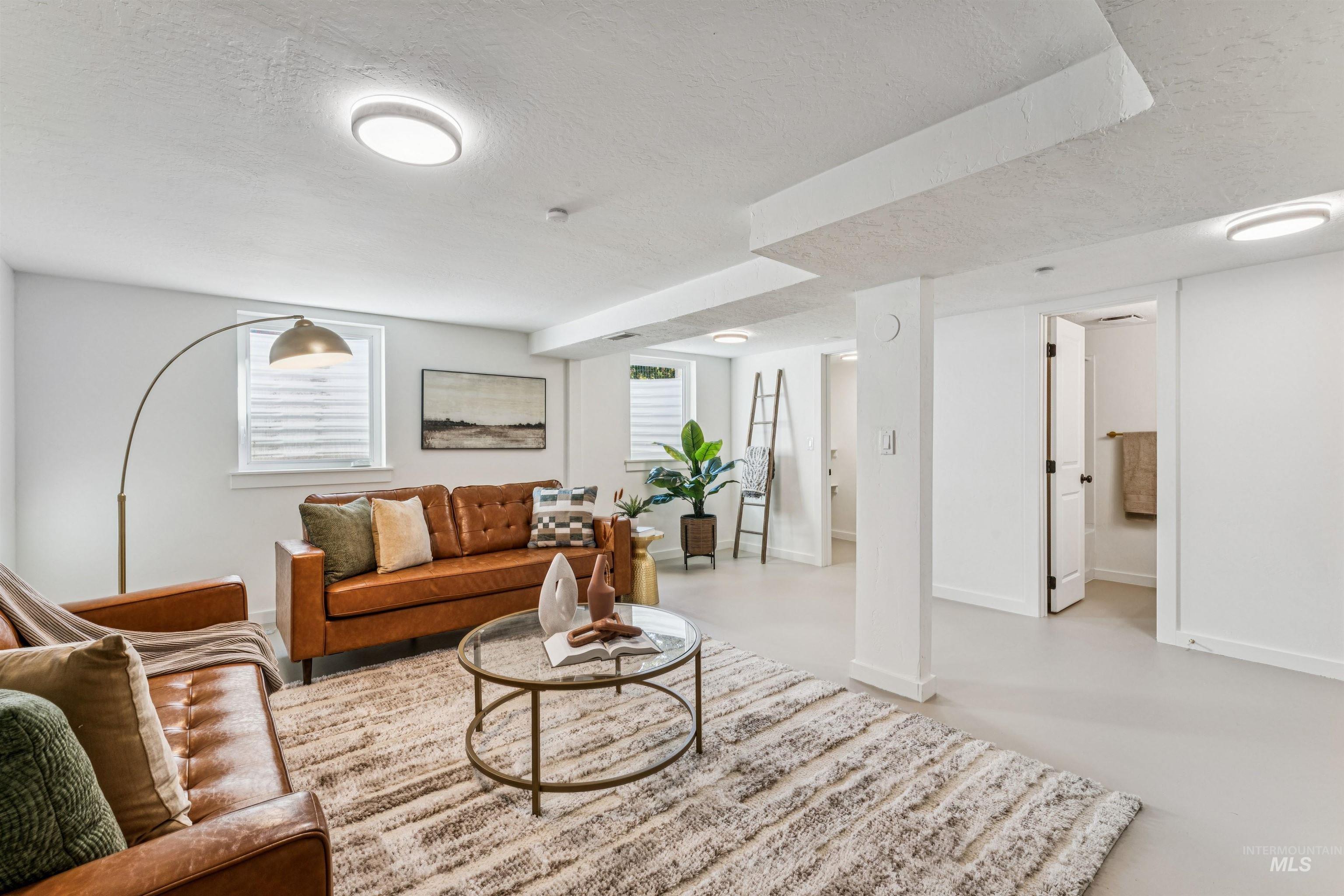 Primary Suite 2 with a textured ceiling and finished concrete floors