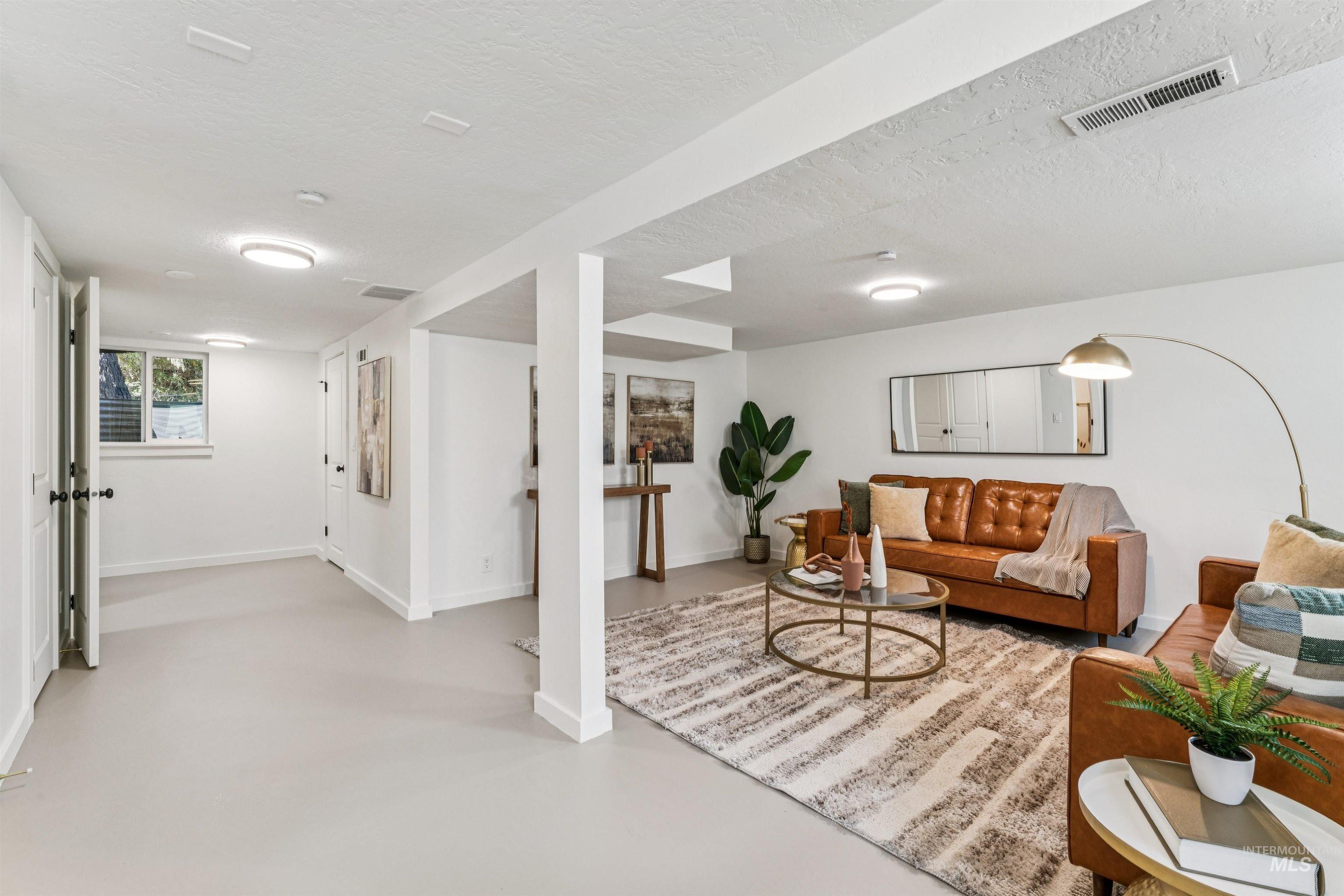 Recreation room featuring concrete flooring and a textured ceiling