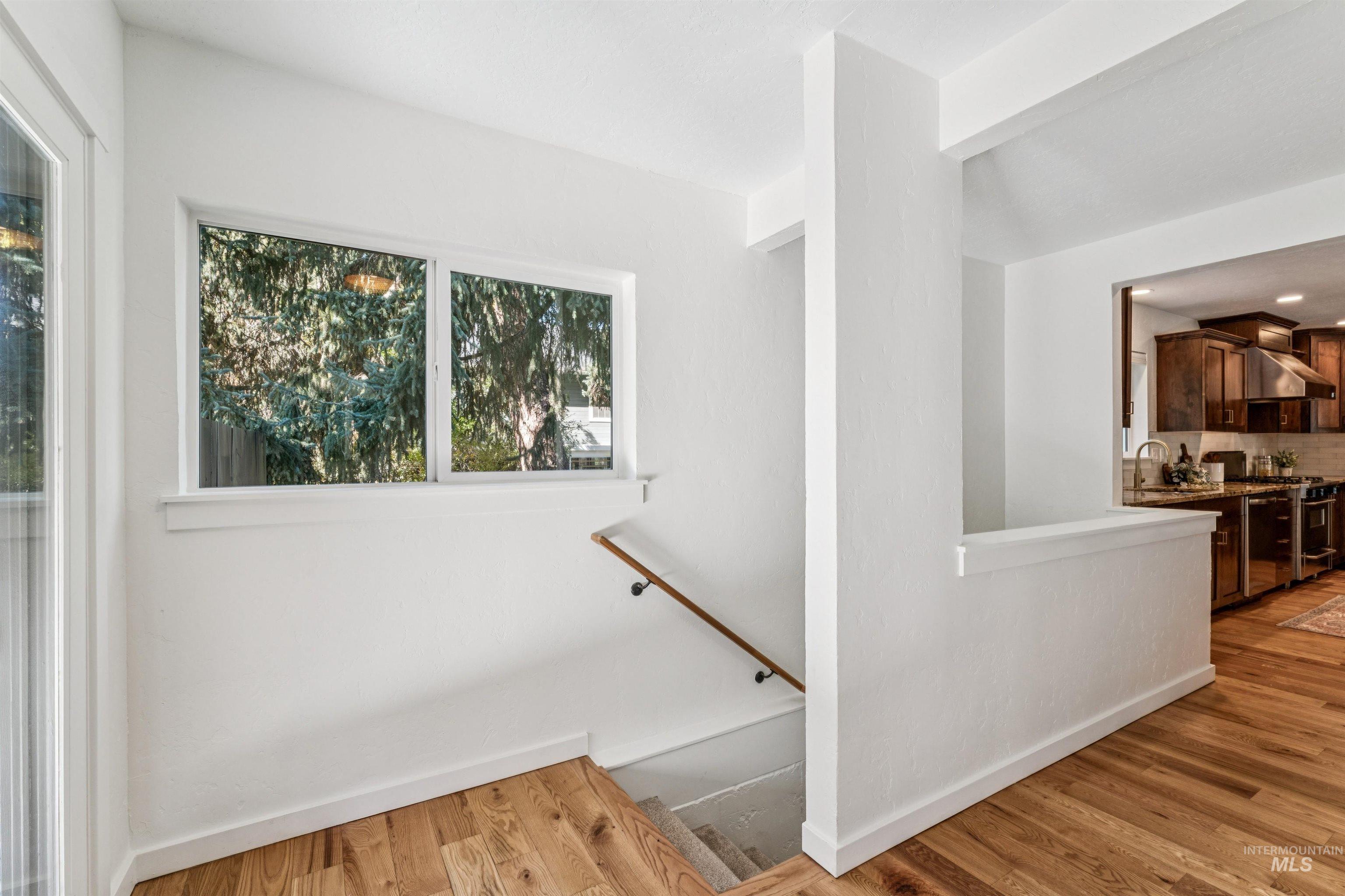 Stairway featuring wood finished floors and baseboards