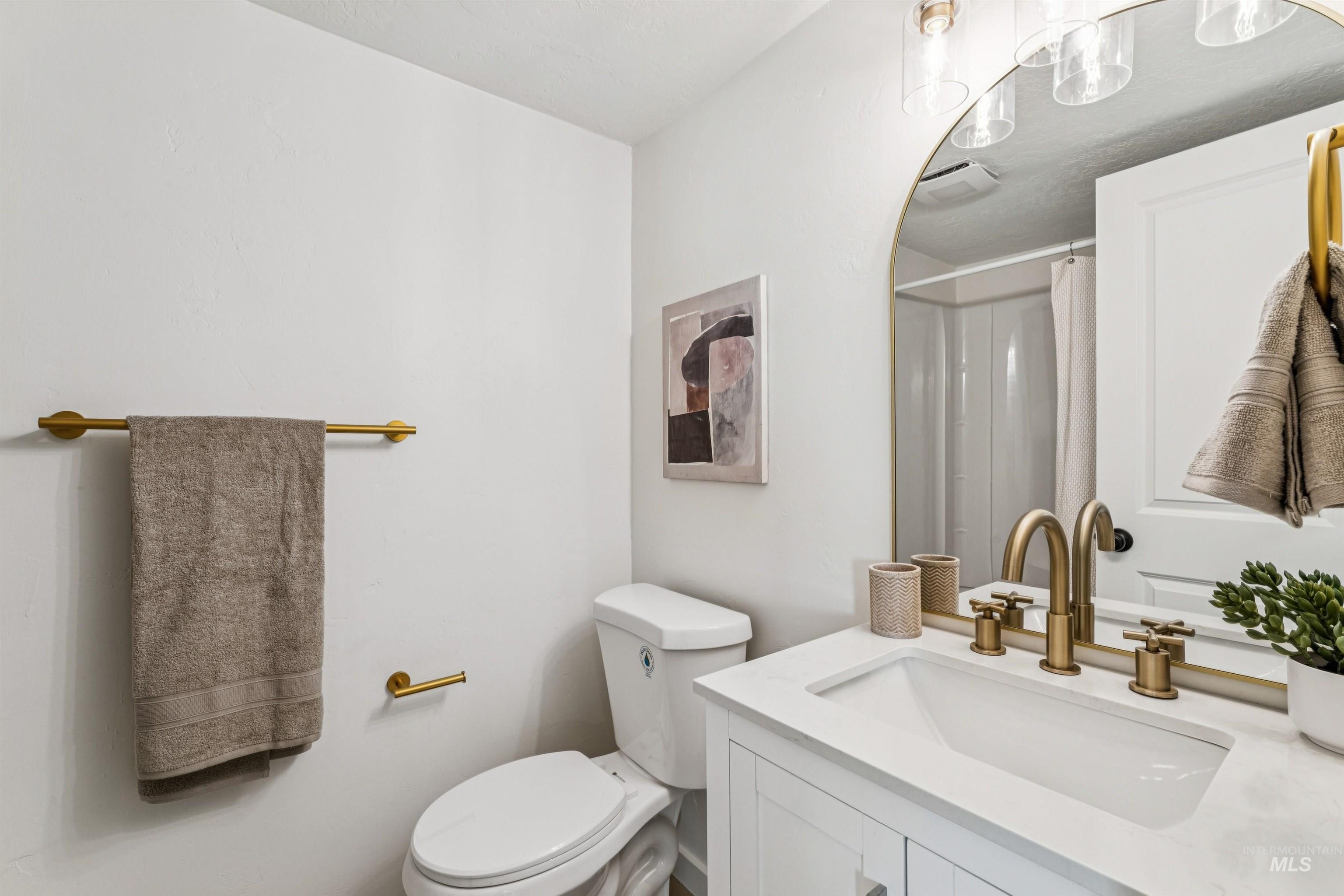 Full bath featuring vanity and curtained shower