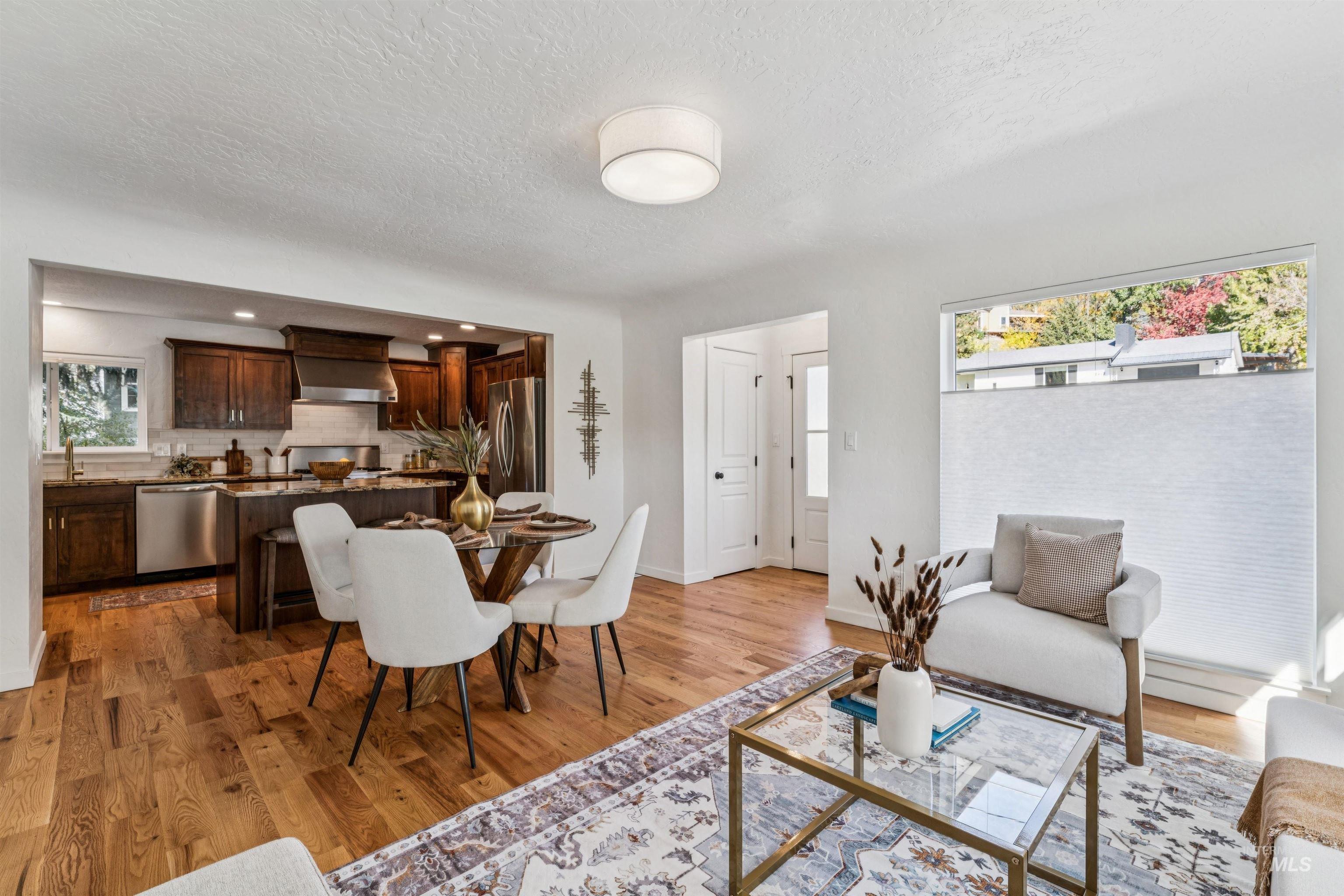 Dining room featuring a textured ceiling and light wood-style flooring